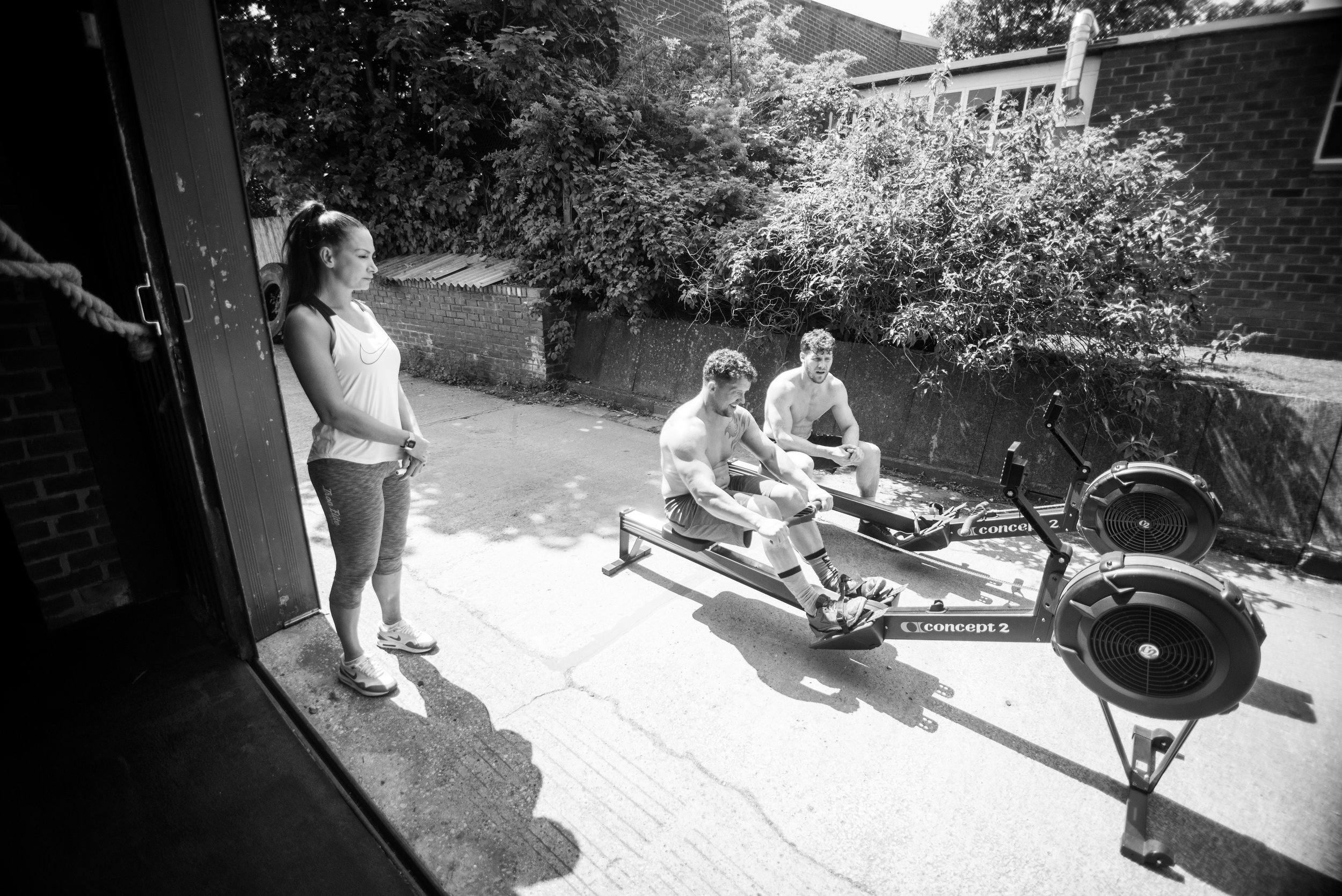 Em (founder of M Squared) and Simon, two of Joyce’s best friends, watch as Marc completes his workout.