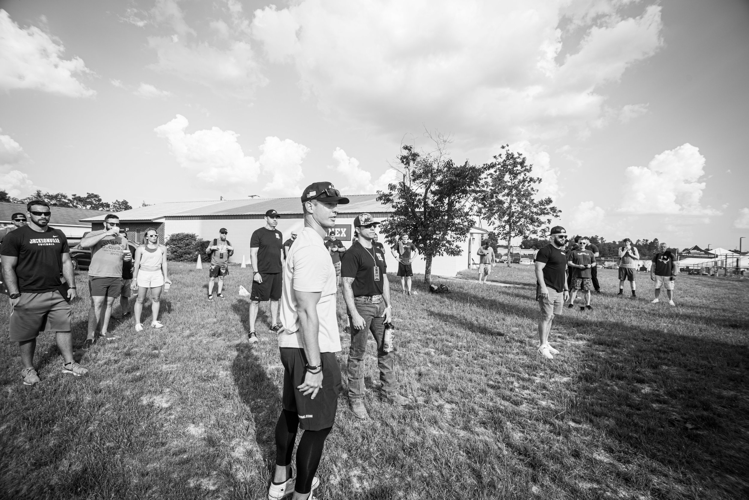 Brady stands and watches friend Brian Peters (NFL) throw axes.