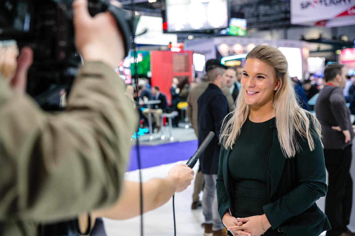 event photography at excel London girl being interviewed whilst filmed by cameraman