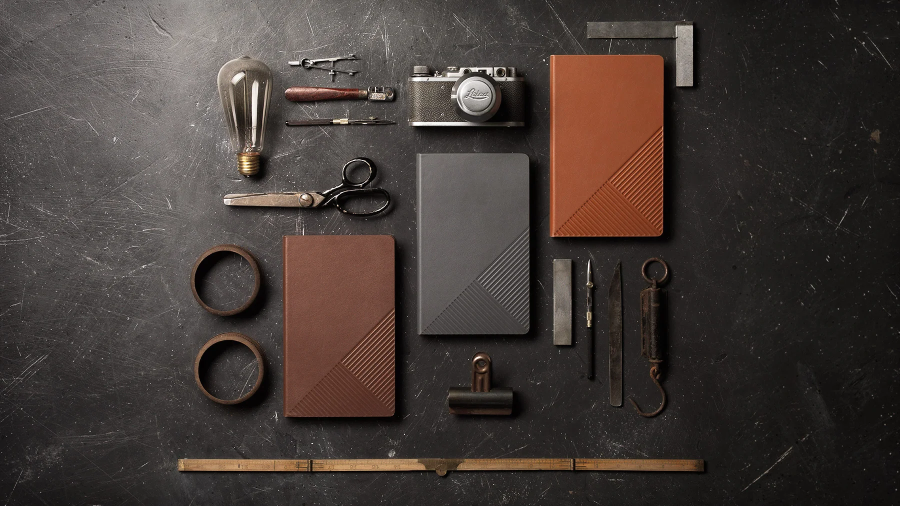 Sample of advertising product photography for a client who produces leather bound diaries, photo taken in studio on slate background, by ADSHOT styled by Lisa Jahovic