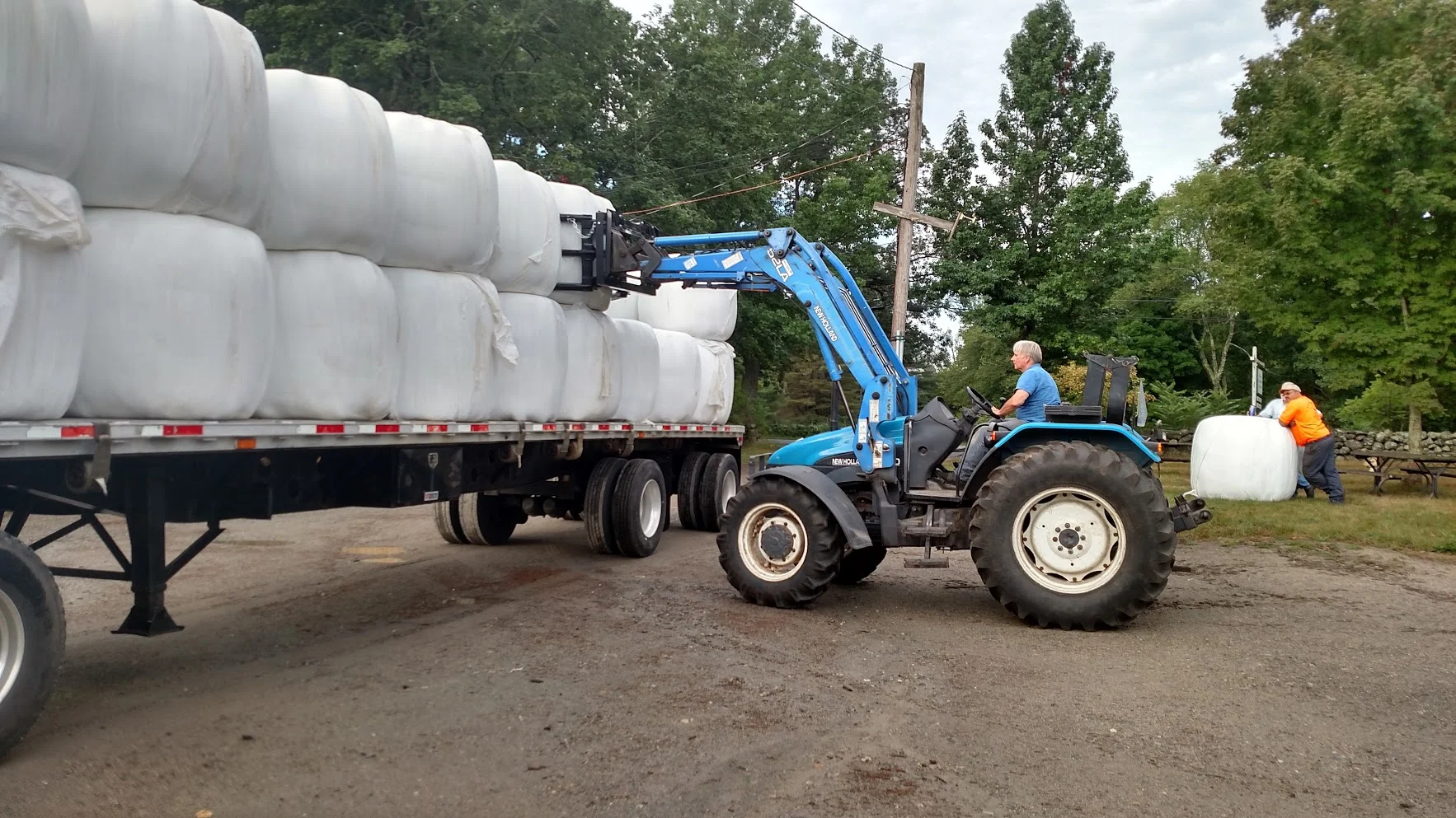 Volunteer and long time friend of the farm George Travis helps unload our first load of hay!