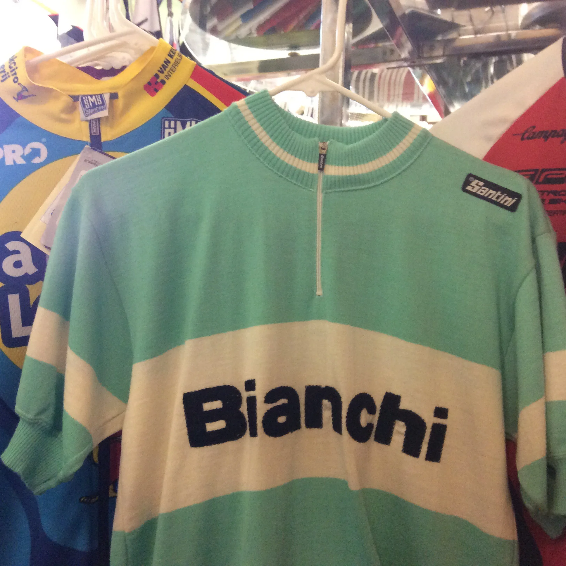Wool Bianchi short-sleeved bike jersey sits on the backroom rack.