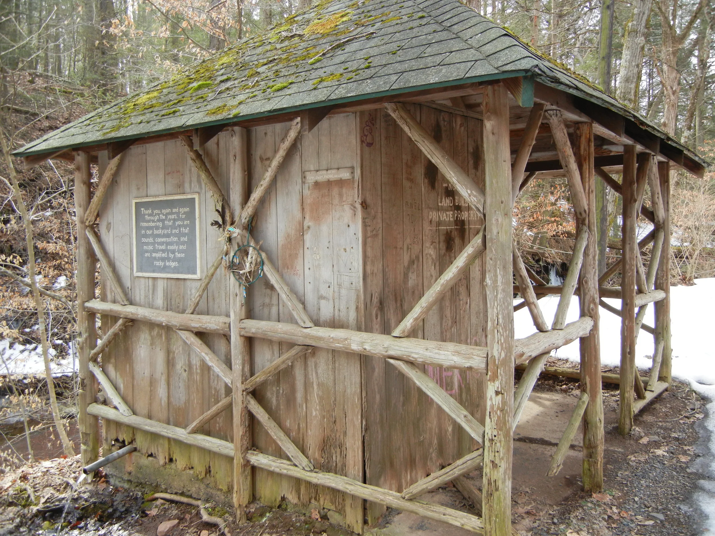 A natural spring on Smithtown Road provides spring water for any passer-by. The pipe to the left is where one can retrieve the water. The sign asks visitors to respect the area.