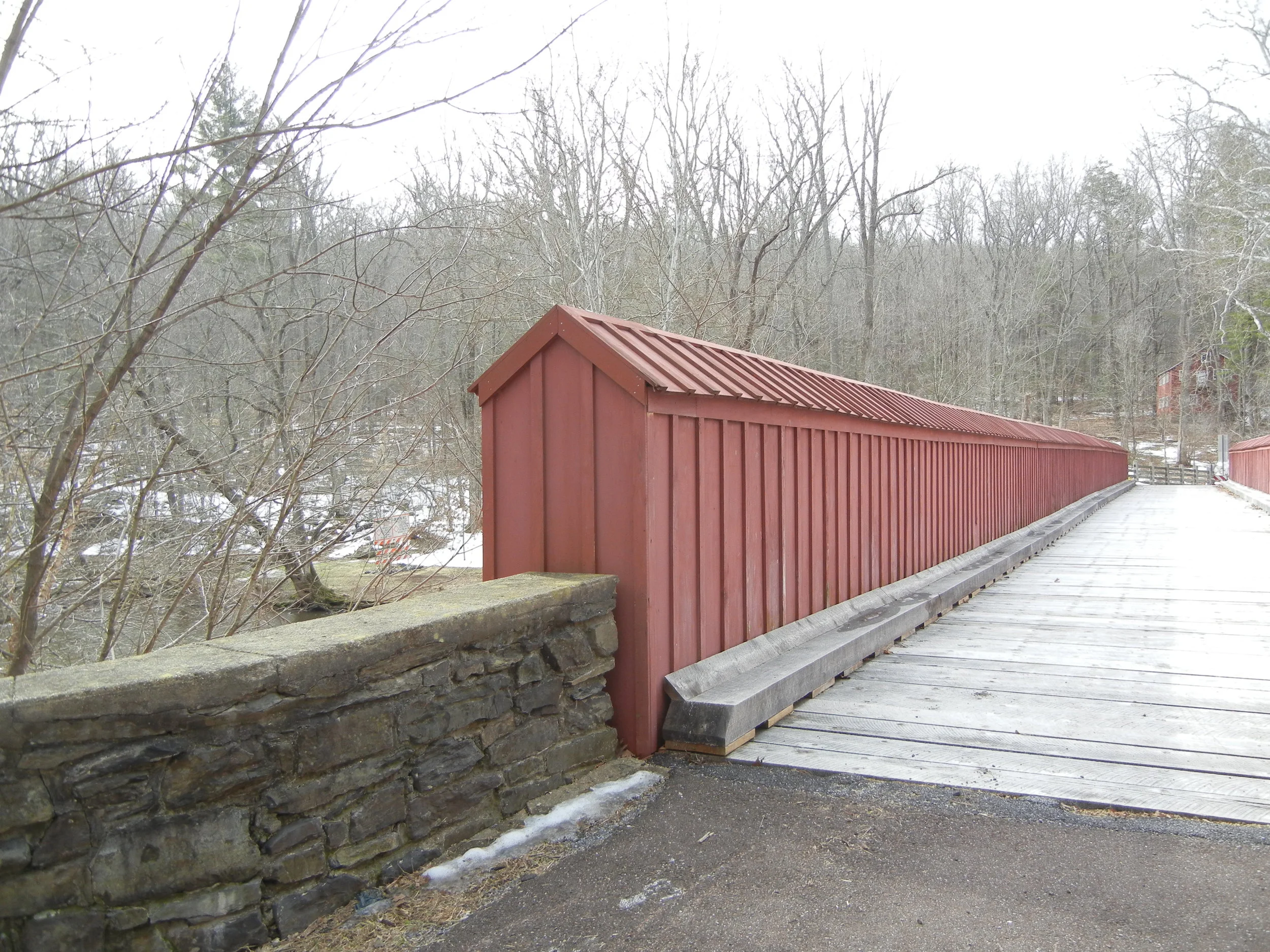 Now a footbridge, this span that connects High Rocks to Ralph Stover used to service motor cars. Cross the bridge and make a left, walk a ways down the bank of the Tohickon Creek, and one will find one of the suspected Doan Outlaws caves.