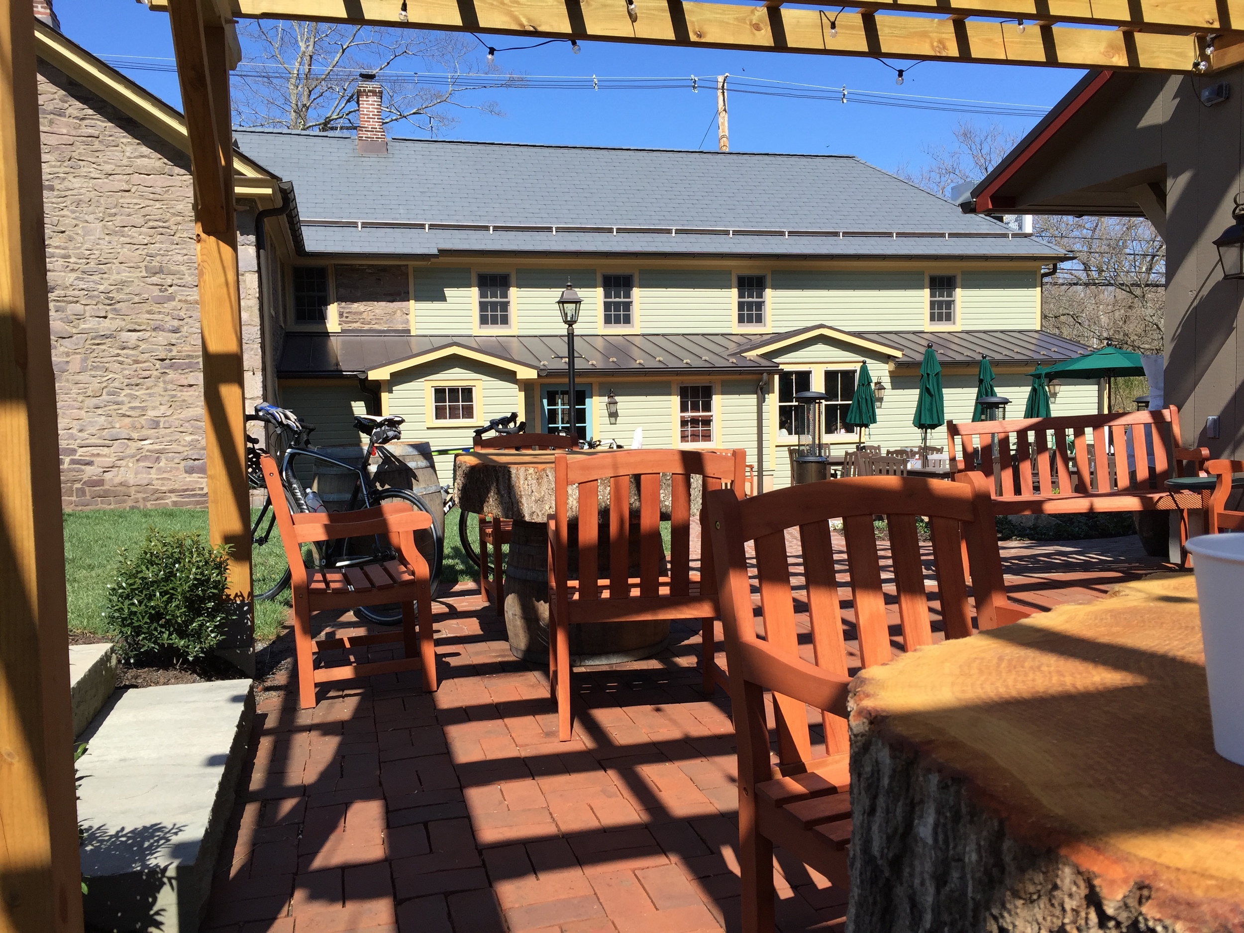 The view from the brick porch where cyclists passing through were gathered. Notice the rustic tabletops.