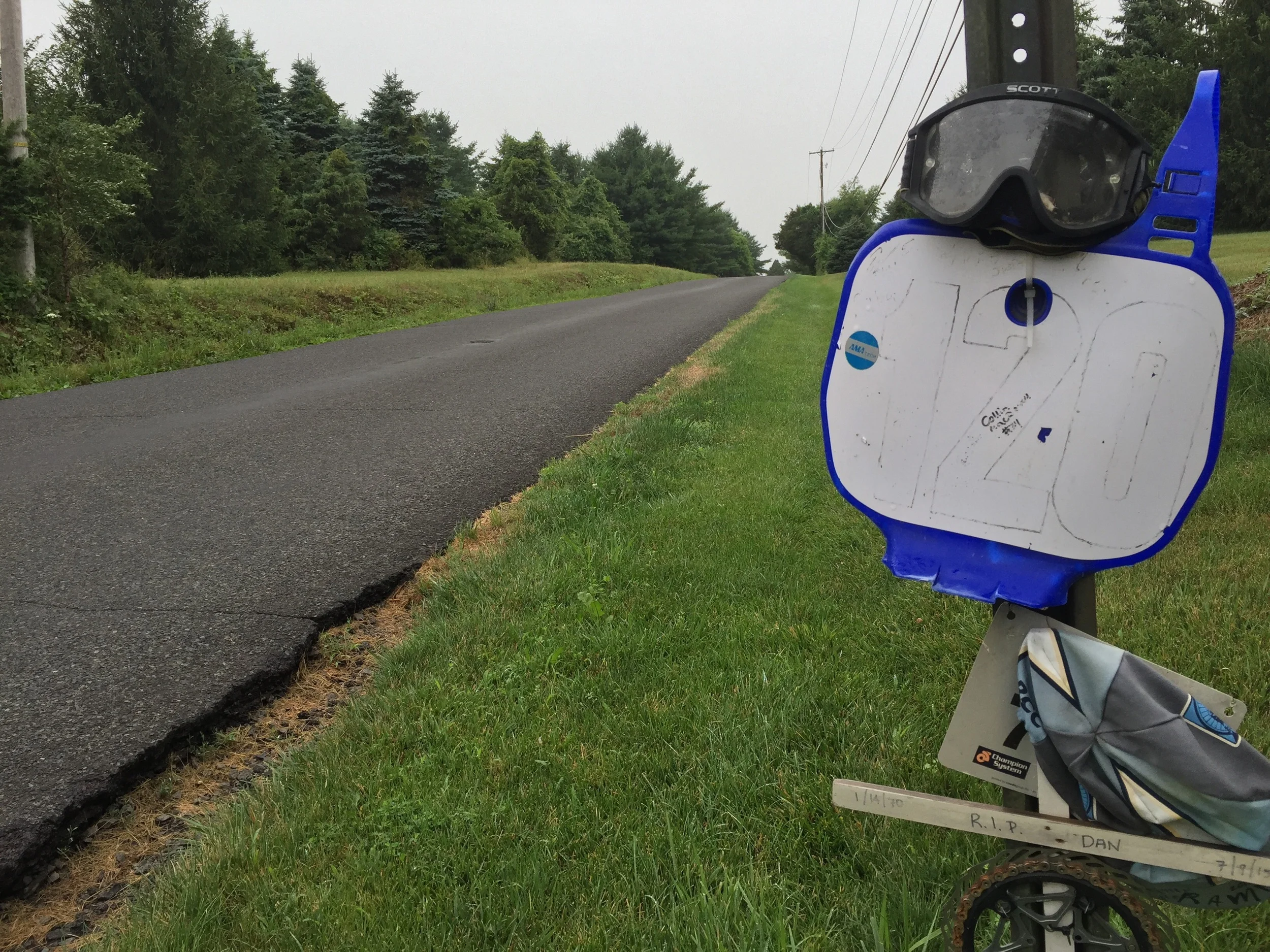 Dan Wilson's motocross number and goggles adorn the sign post on Ervin Road. I waited for the paint markings to fade away before photographing this memorial.