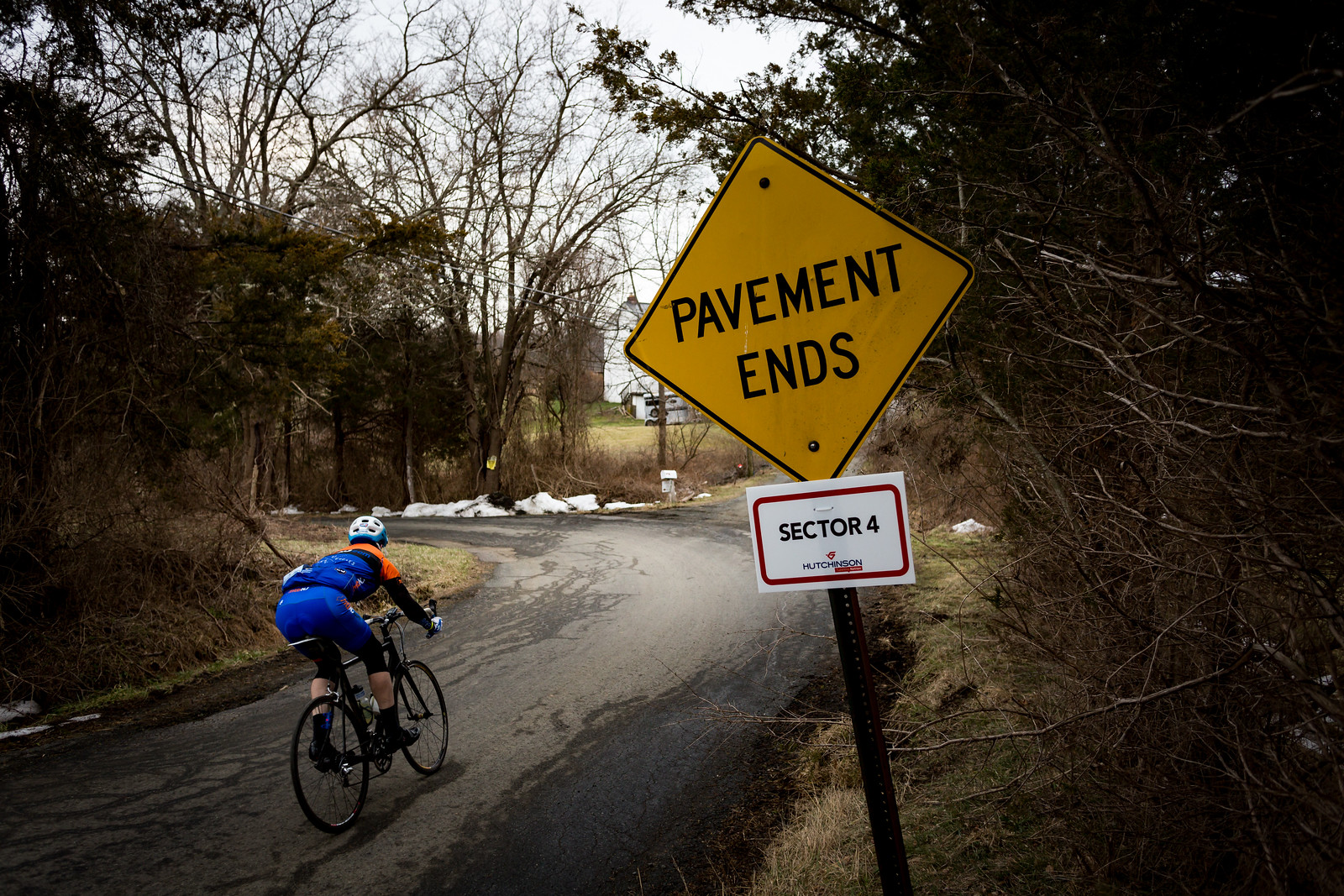 Hutchinson Tires again sponsored the unpaved sectors by counting down the progress. Each section started with a sign like this and finished with a satisfying slash, much like the Paris-Roubaix. Here a rider navigates a sharp turn on Hunter Road where it becomes gravel. Photo courtesty Mike Maney.