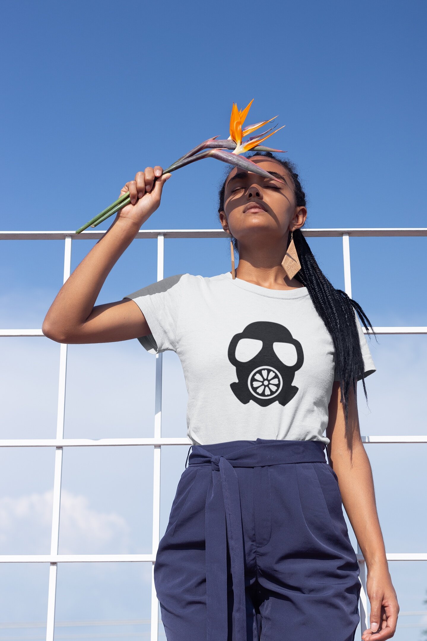 t-shirt-mockup-of-a-girl-with-braids-holding-a-bird-of-paradise-flower-21806.jpg
