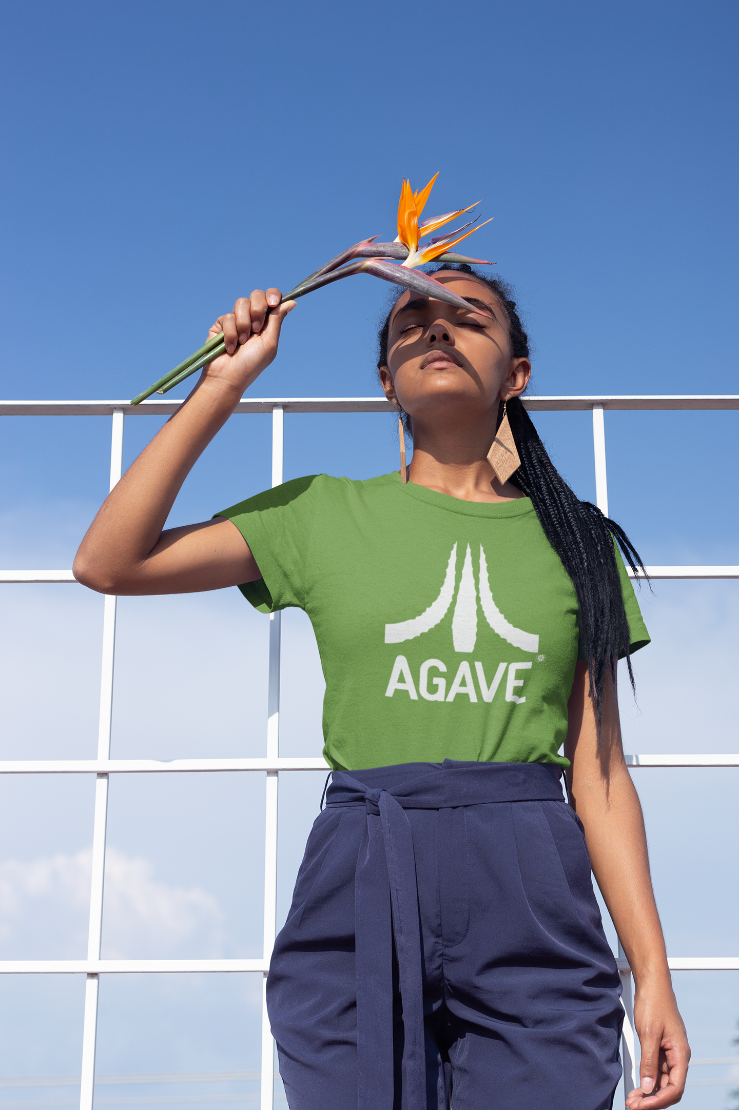 t-shirt-mockup-of-a-girl-with-braids-holding-a-bird-of-paradise-flower-21806.png