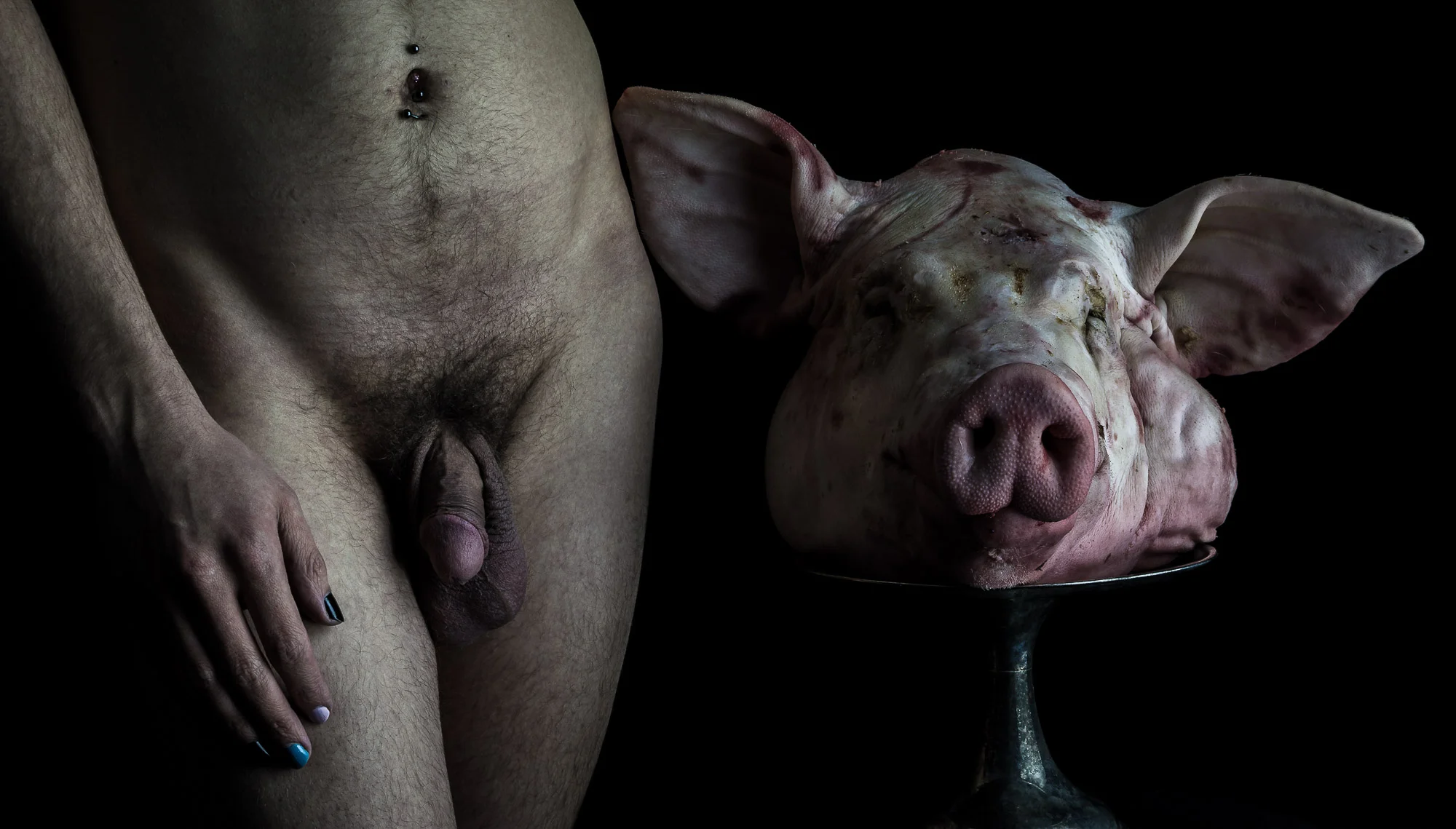 My portrait of model Oscar James grace with the severed head of a pig.