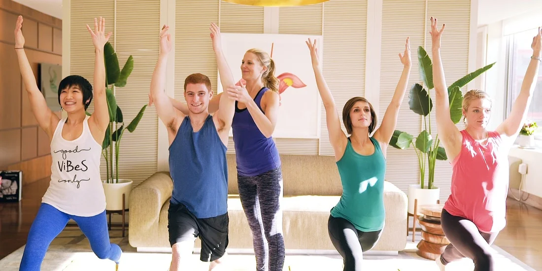 hOM employees doing yoga together, including co-founder and CRO Ryan Freed