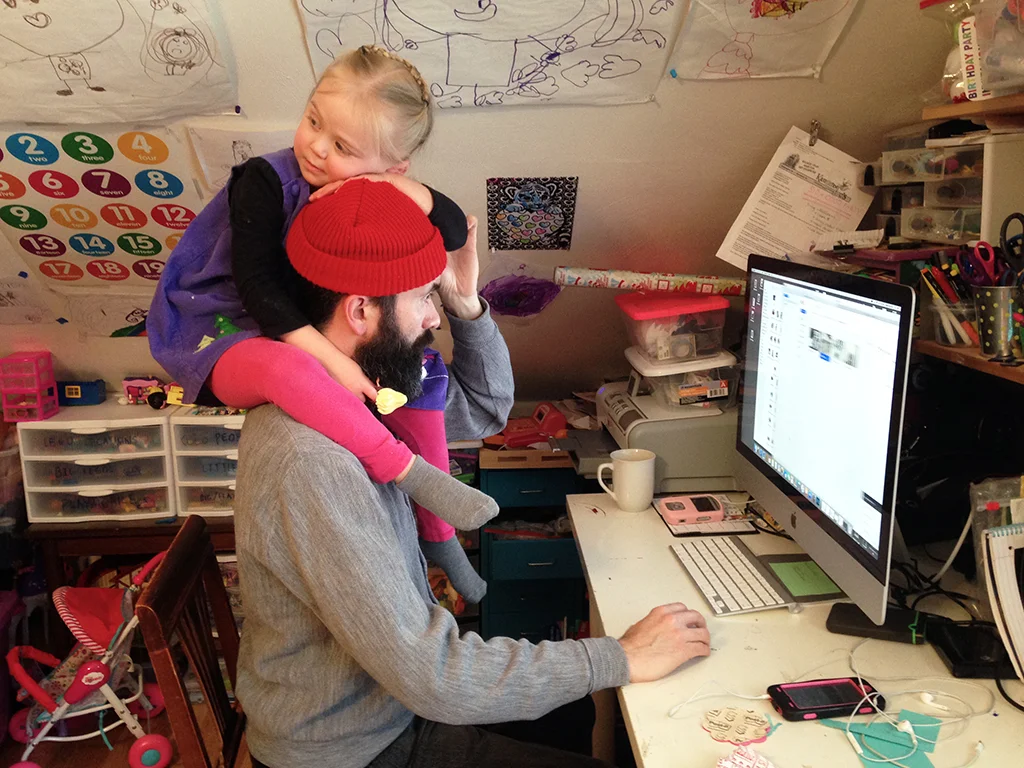 My husband Blade managing to work at the computer with our daughter on his shoulders