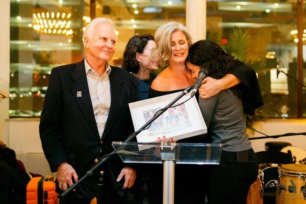 Catherine DeLaura is congratulated by her goddaughter for receiving the DREAMer of the Year Award
