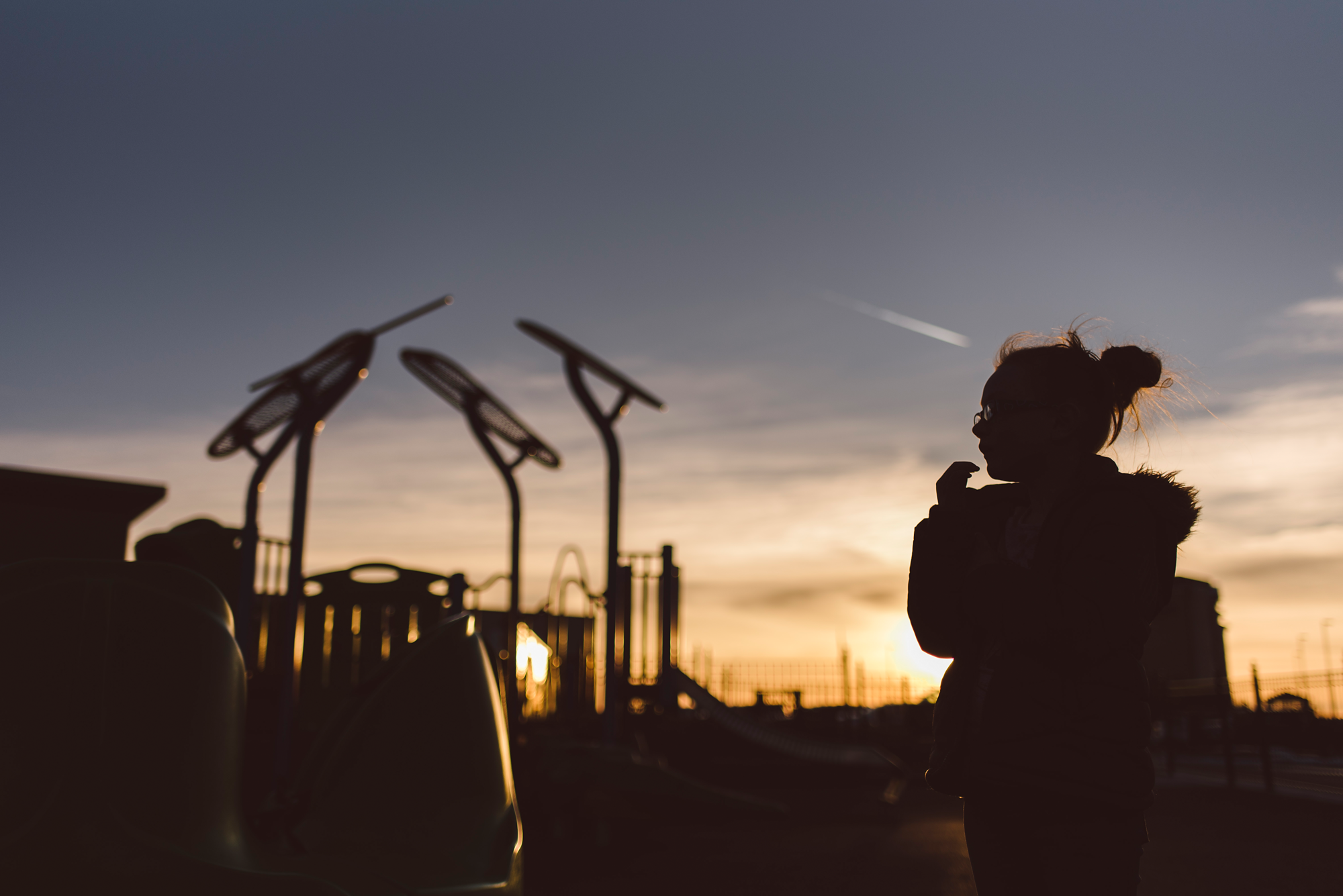 Silhouette of girl at park at sunset