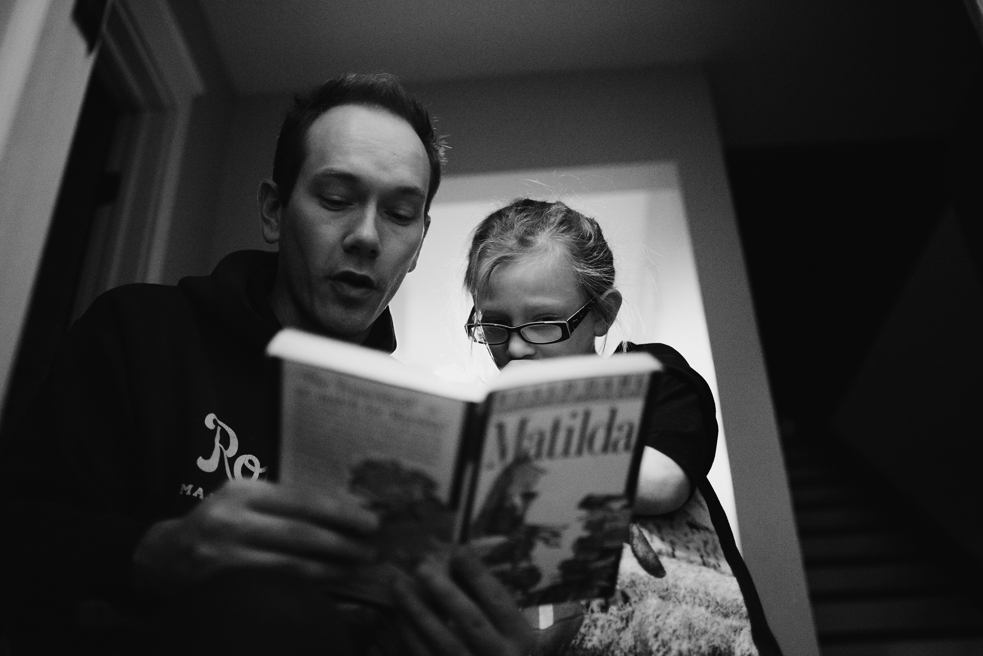 Father reading Matilda to daughter