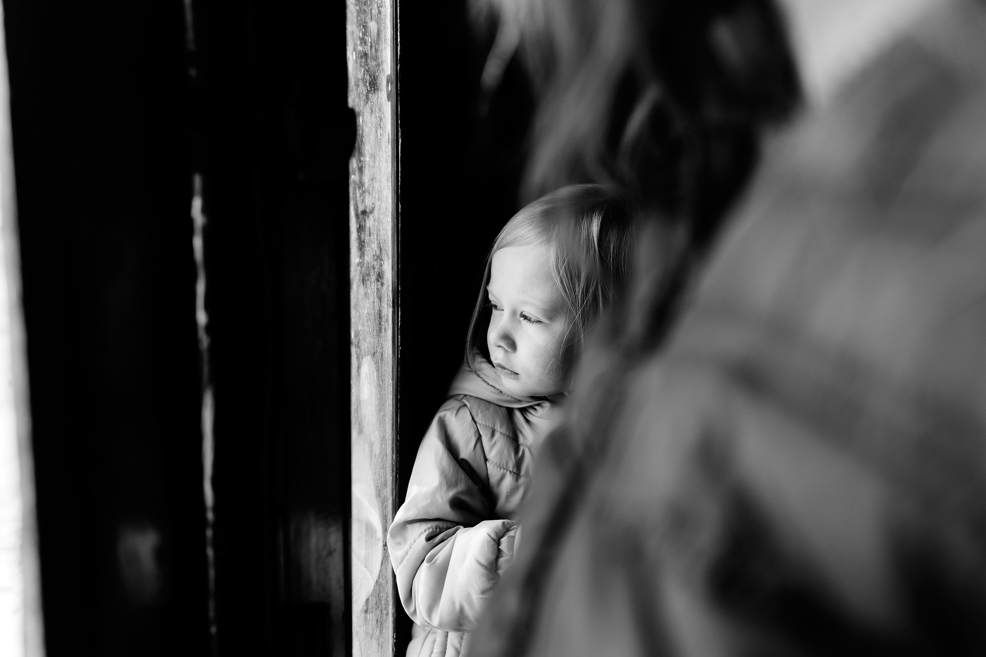 Girl looking out door