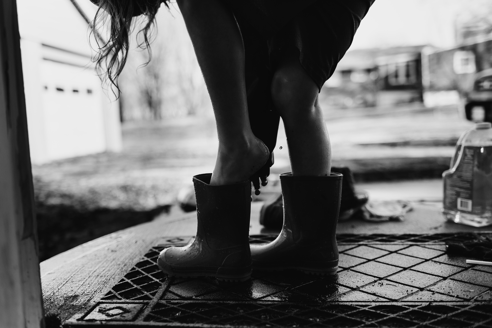 Silhouette girl putting on boots