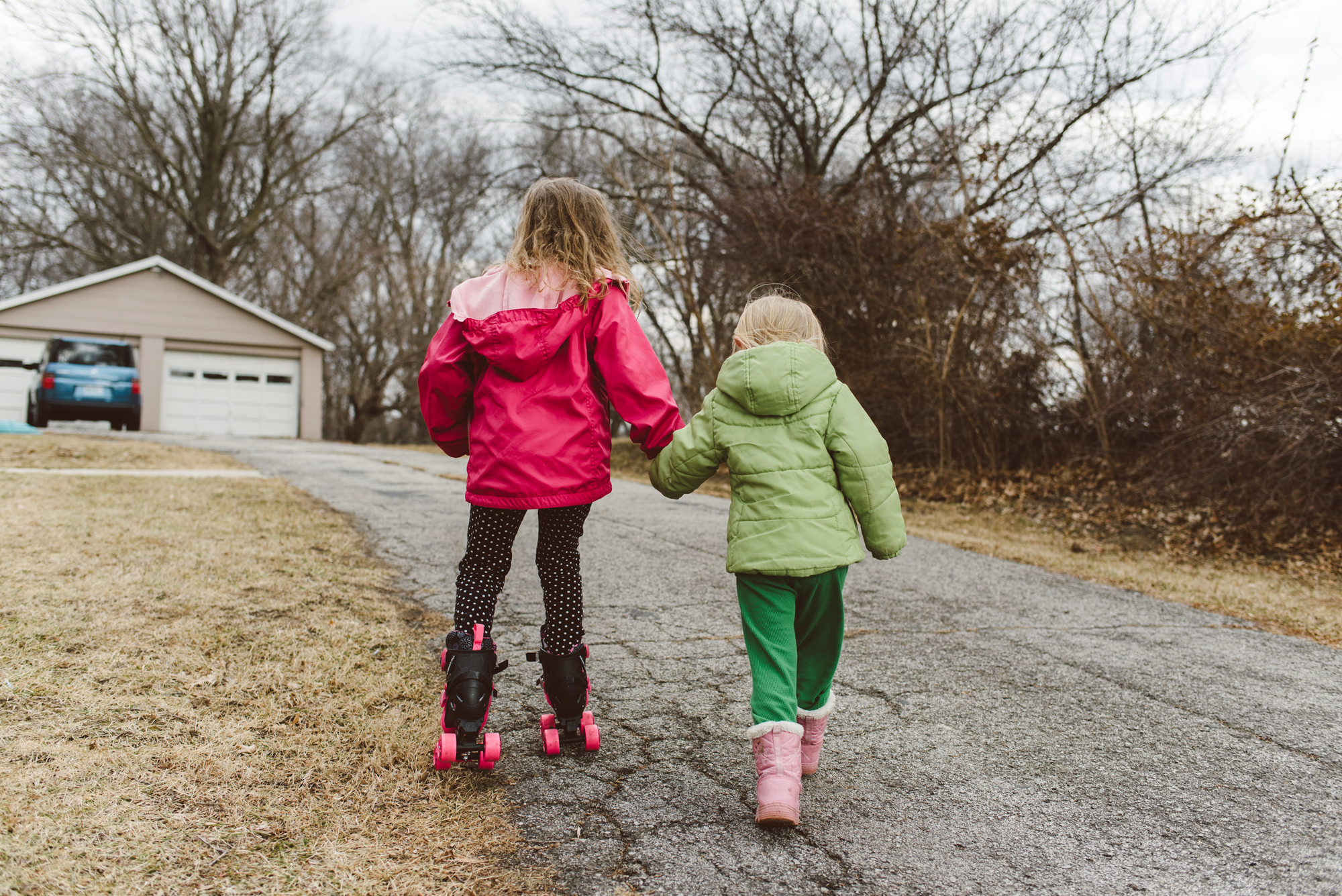 Sisters holding hands walking away