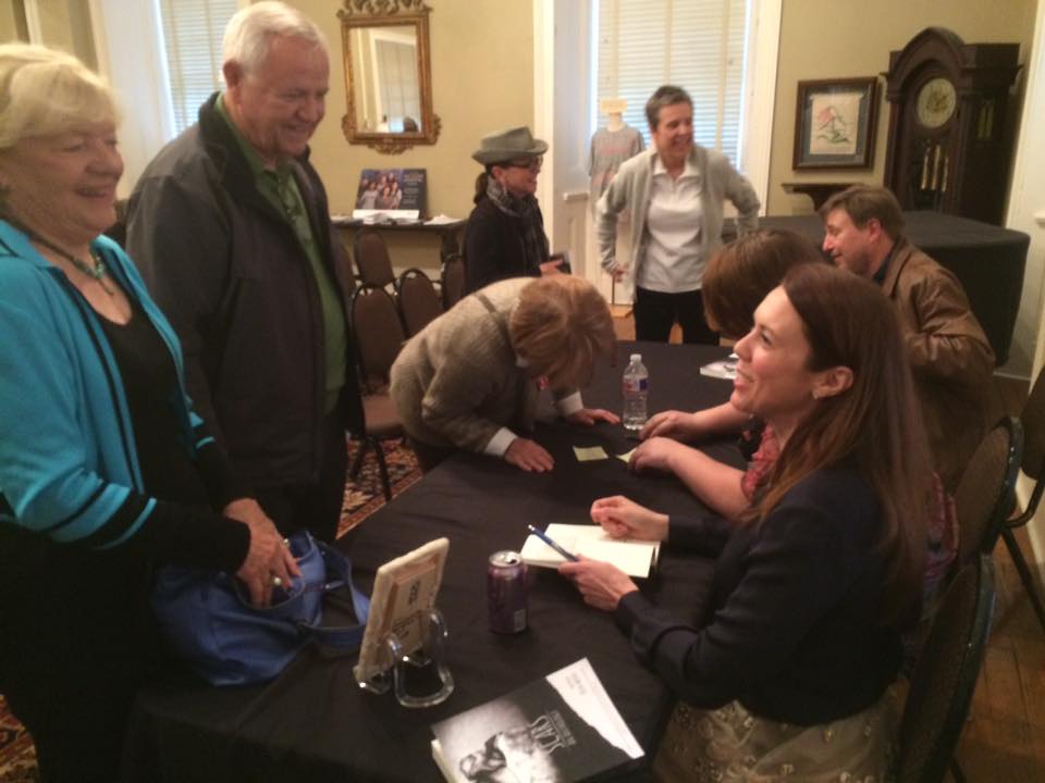 Erin Wood signs a copy of Scars for former Congressman Ed Bethune and his wife, Lana, during the Scars panel at the MacArthur Museum of Arkansas Military History during the 2016 Arkansas Literary Festival. Photo courtesy panel mediator Michael Hibblin of KUAR radio. 