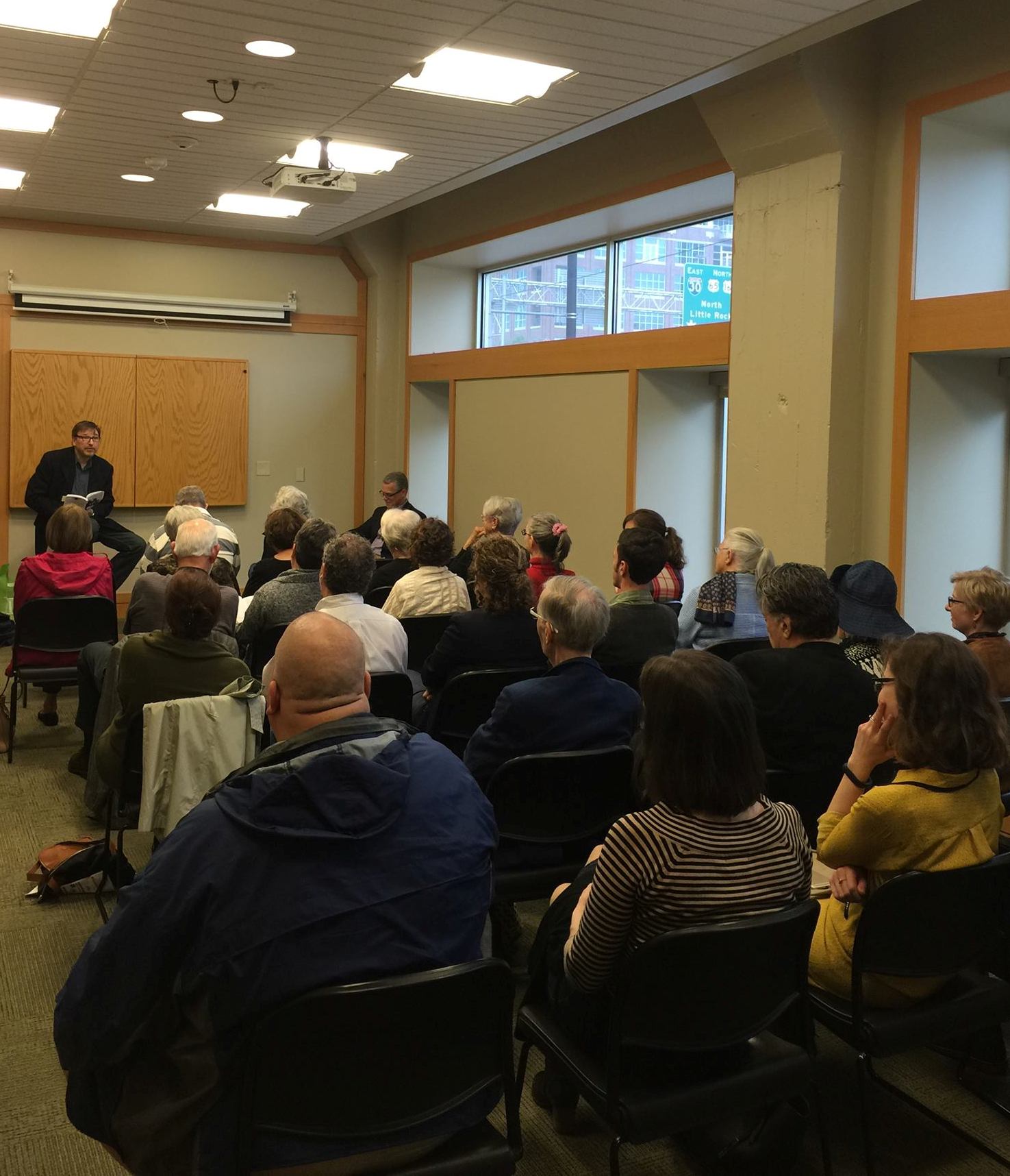 Philip Martin reads, plays his guitar, and sings from his collection, The President Next Door: Poems, Songs, and Journalism , at a session of the 2016 Arkansas Literary Festival. 