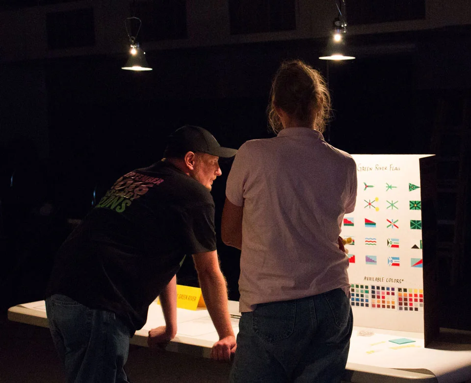 Travis Bacon and Gayna Salinas discussing the flag design at the downtown workshop.