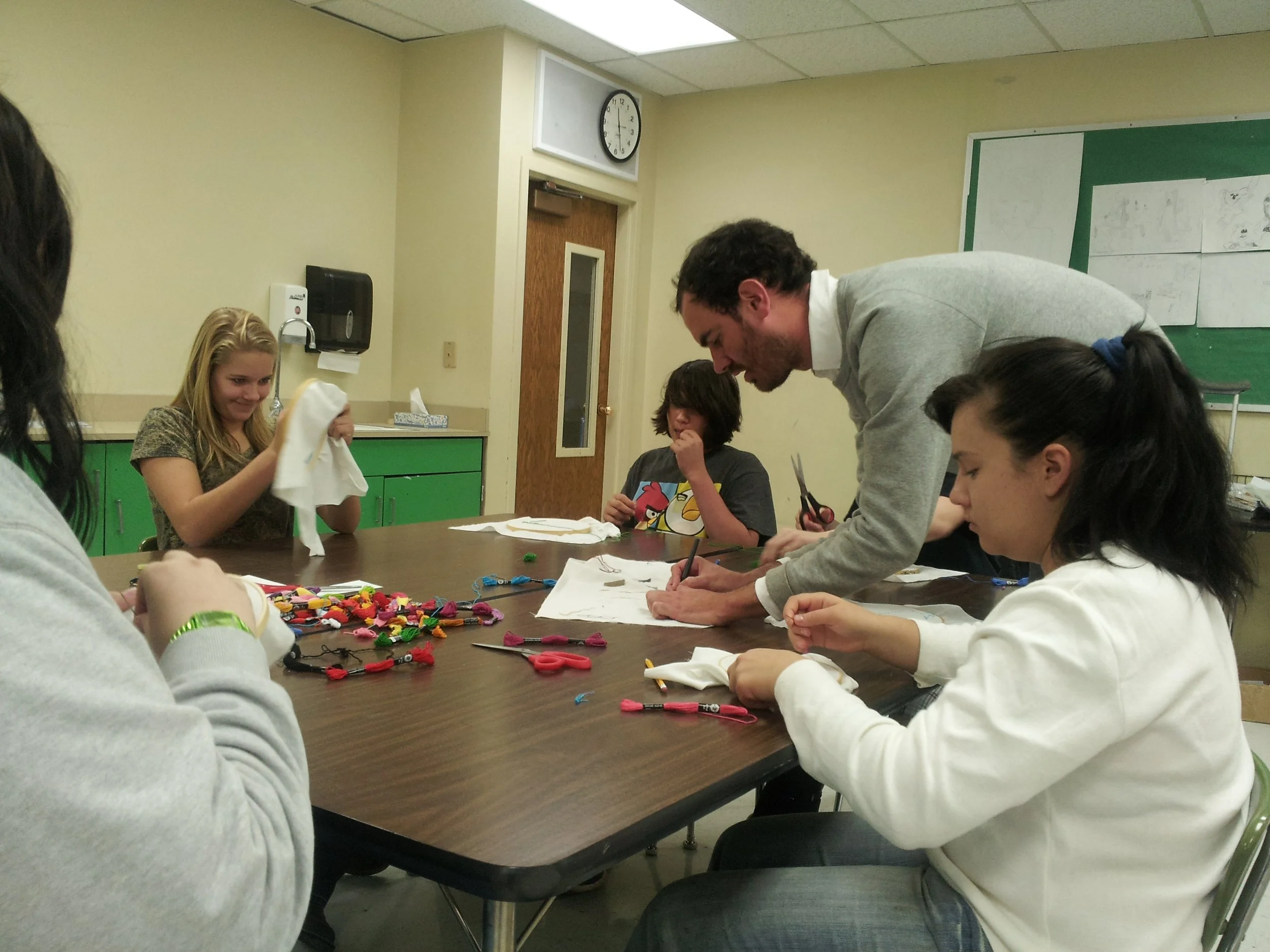 Creeden teaching an embroidery class at Green River High School