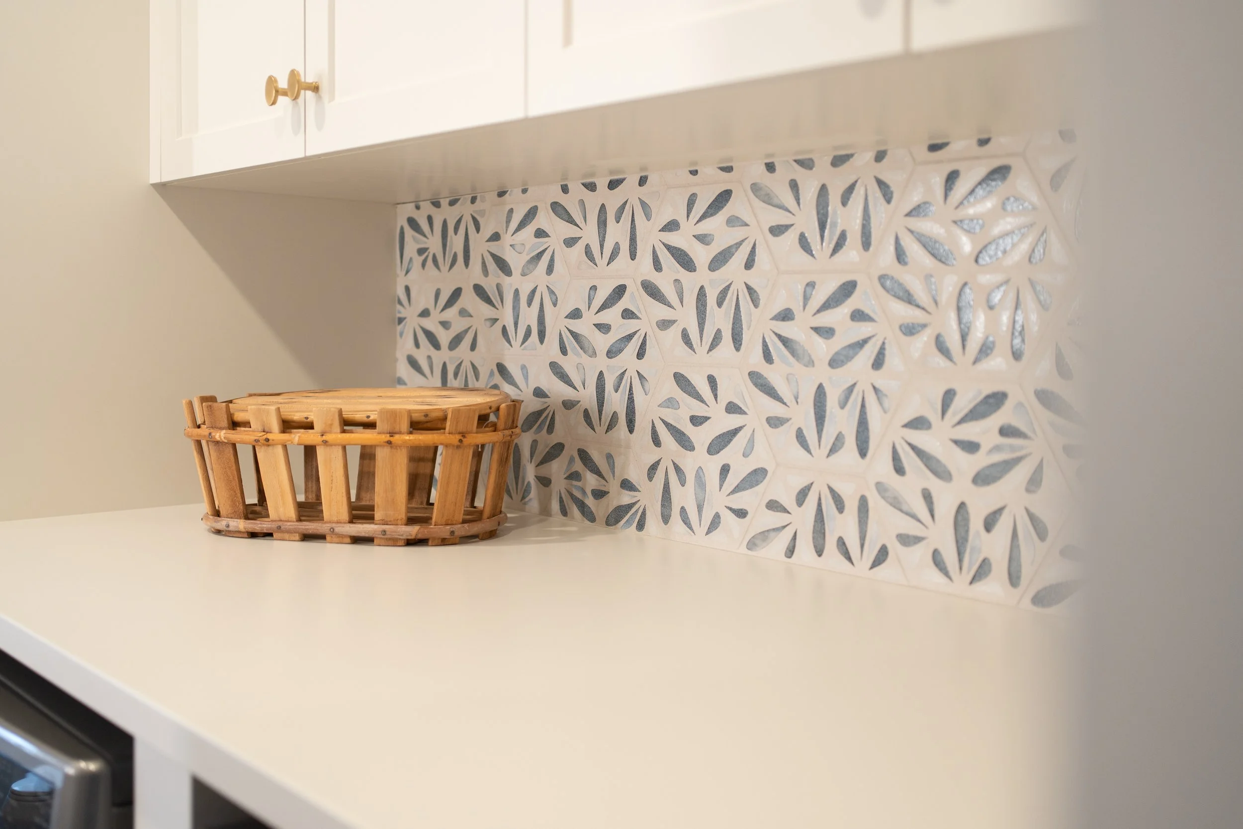 Laundry and ensuite space featuring blue tile and clean, modern finishes
