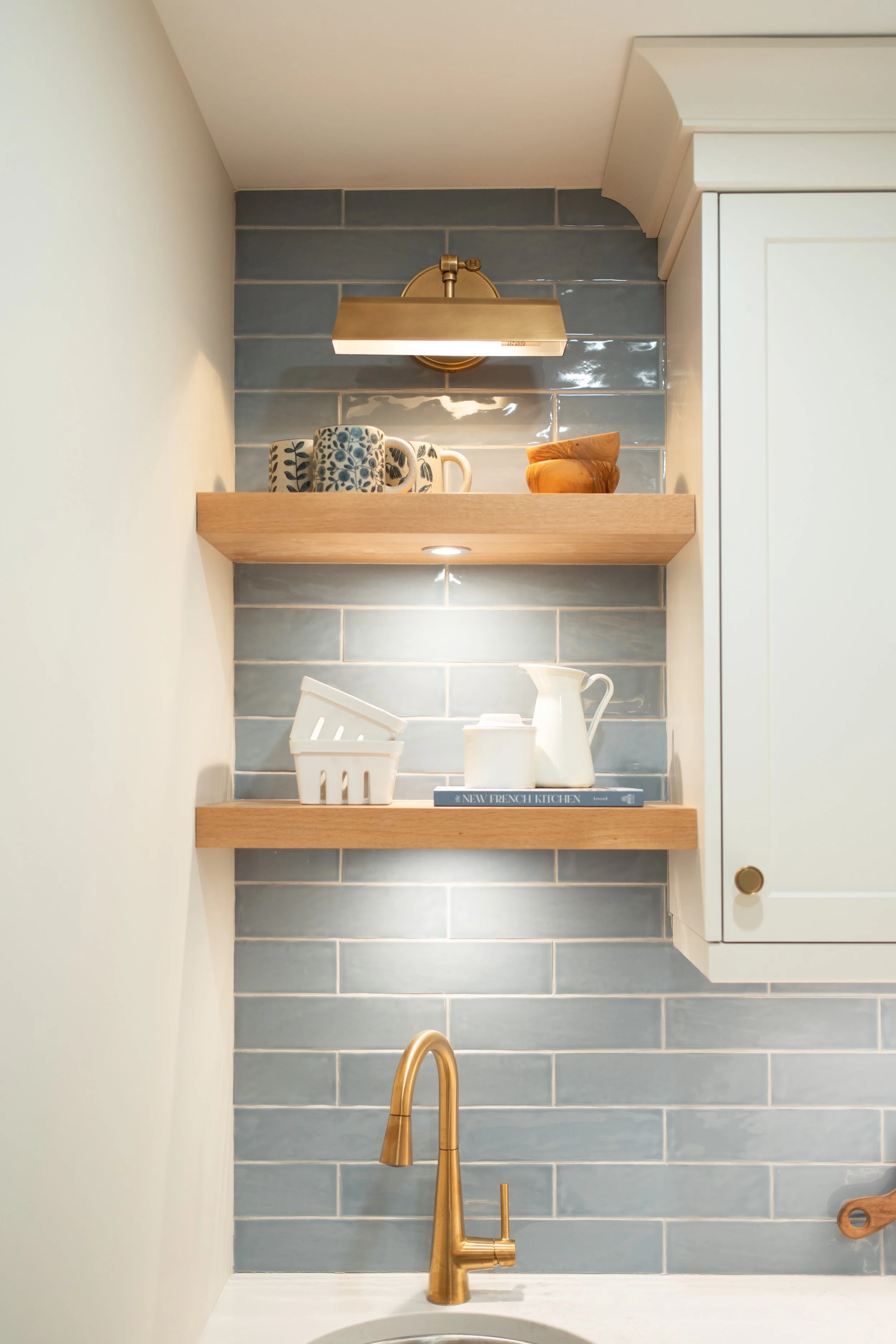 Butler’s pantry with blue cabinetry and a checkerboard floor