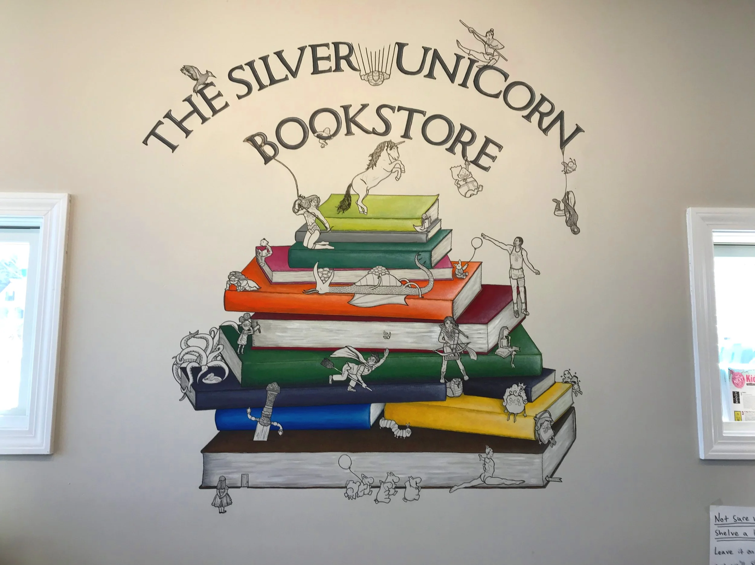 The mural, designed by Kirsten Spargo, is an iconic store feature. Can you name all the characters?