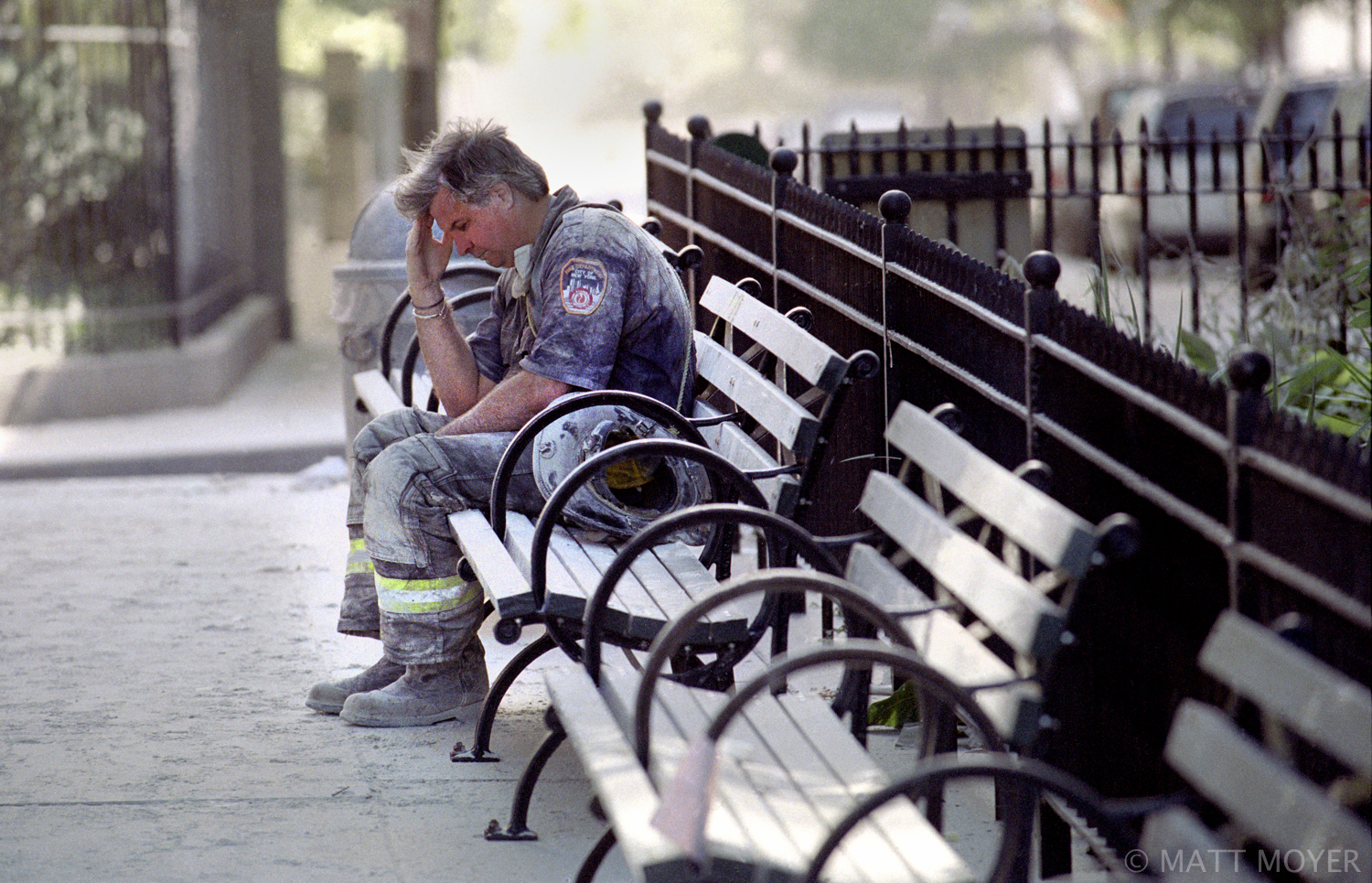  FDNY firefighter, Dan Potter, pauses on a bench in Lower Manhattan after the collapse of the World Trade Center on Sept. 11, 2001. 
