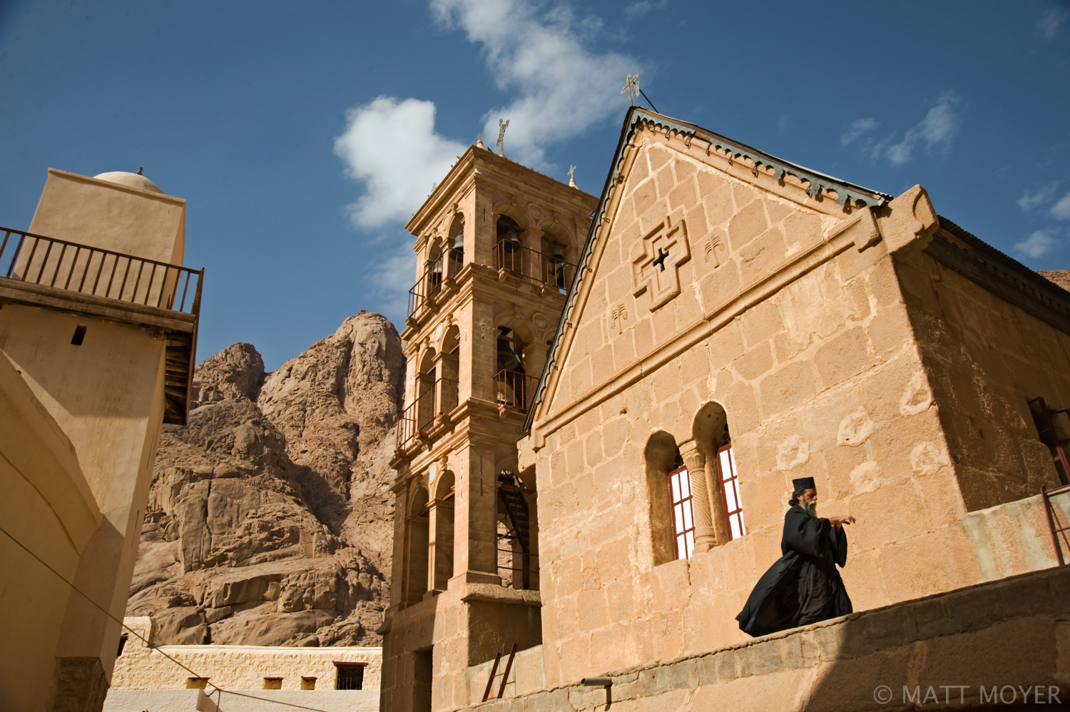  A monk walks in front of the main chapel inside the walls of St. Catherine's Monastery. 