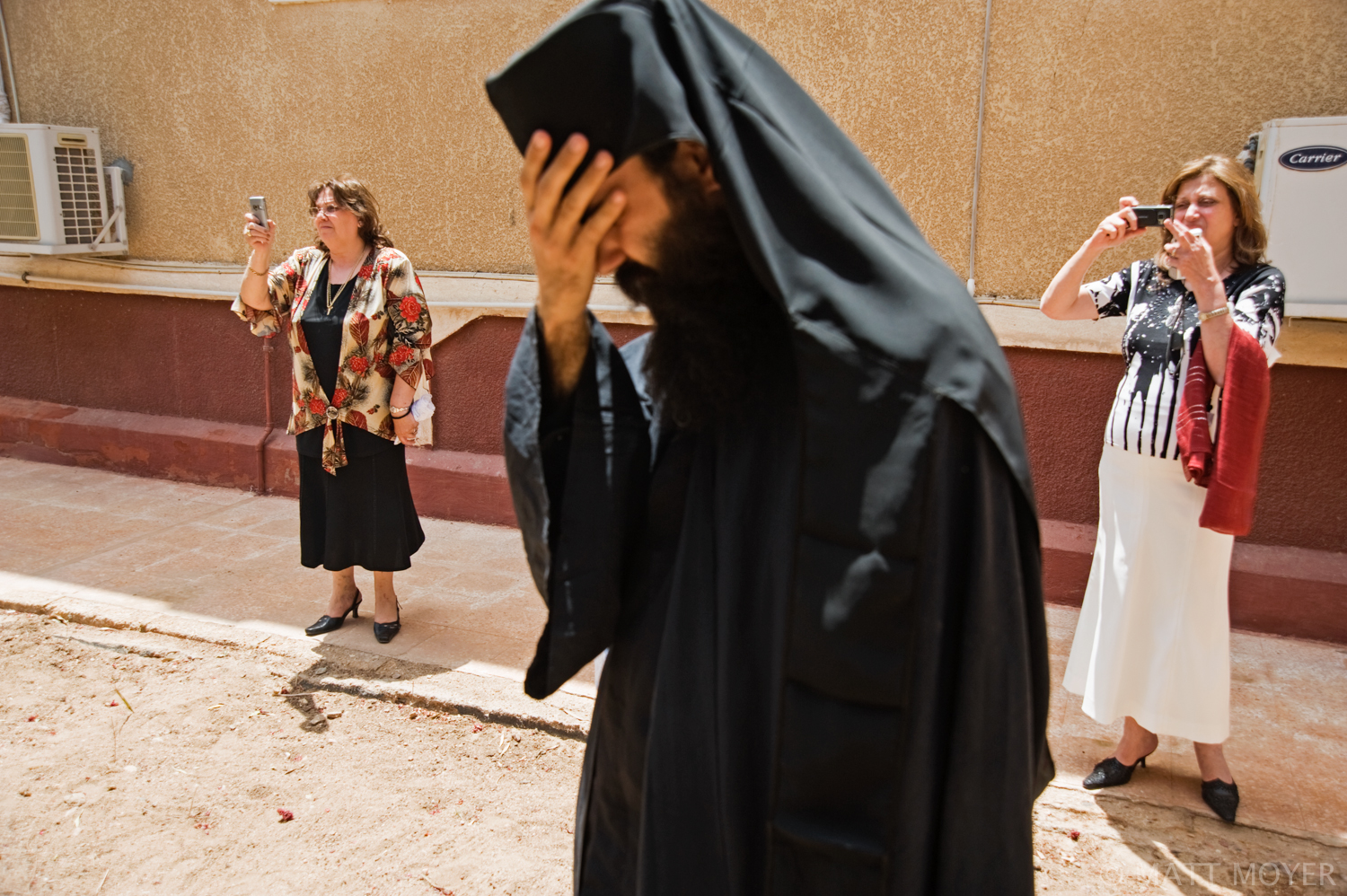  A monk of the Saint Catherine Monastery reacts as tourist take photographs of a religious procession. Tens of thousands of tourist descend upon the ancient monestary every year. 