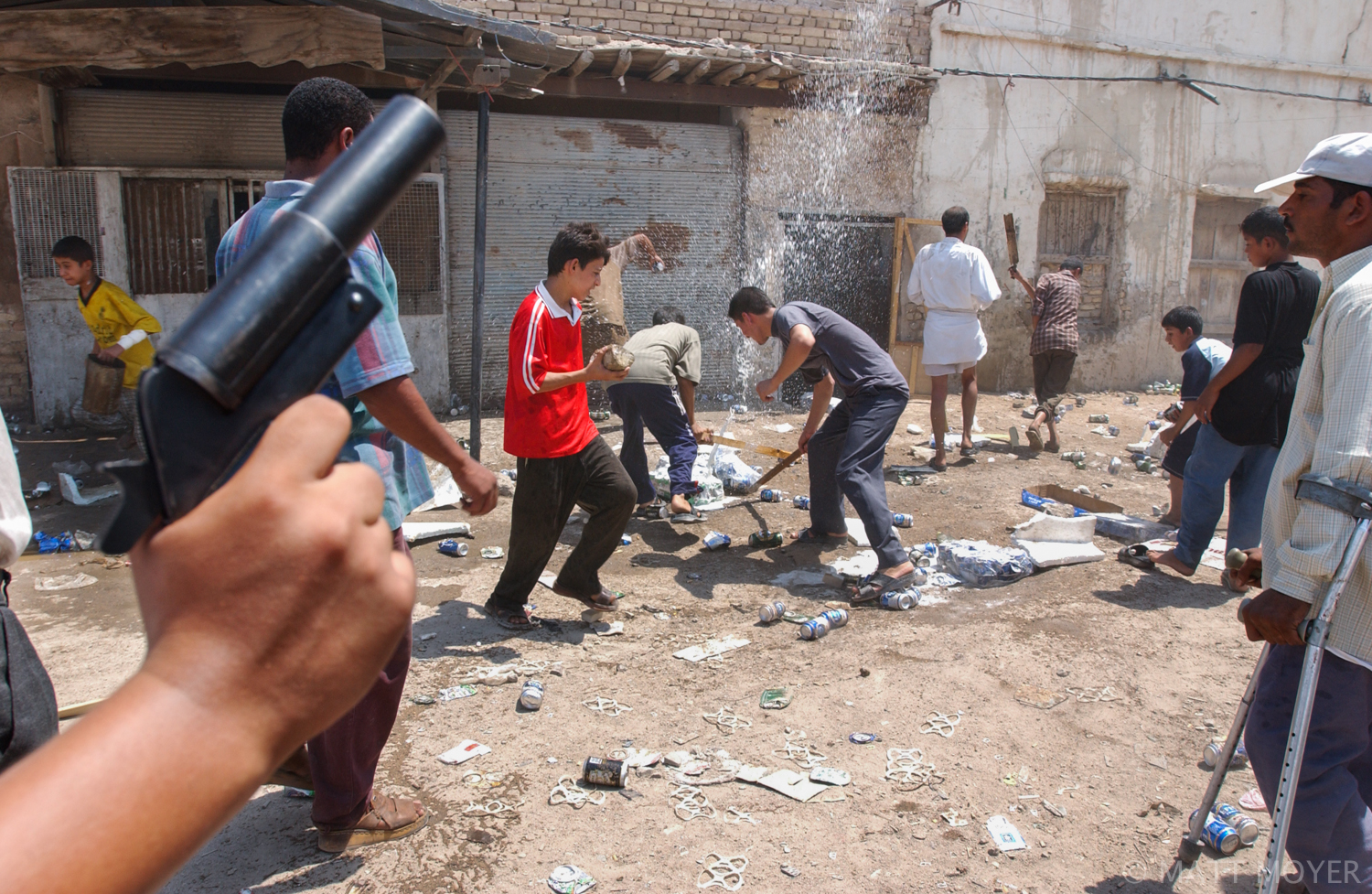  Members of a mob attack a brothel and destroy cases of beer found inside in the Old Basra neighborhood of Basra, Iraq.  The mob, made up of men and boys from the neighborhood and a few Islamists, threw stones at the prostitutes as they ran for their