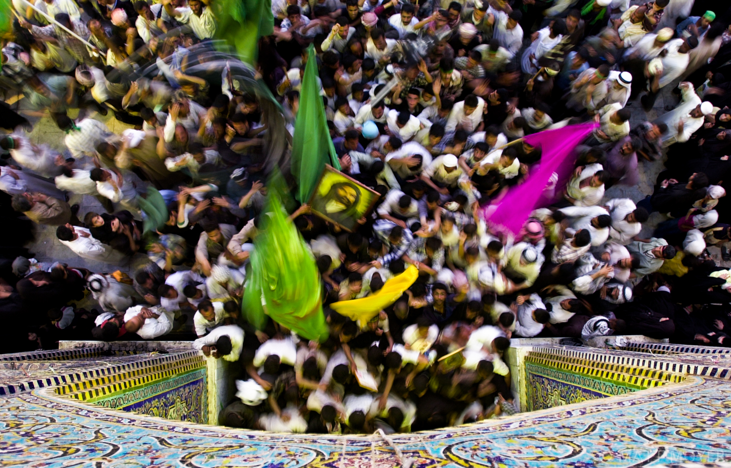  Worshipers flood toward the exit of a shrine in Karbala, Iraq.  