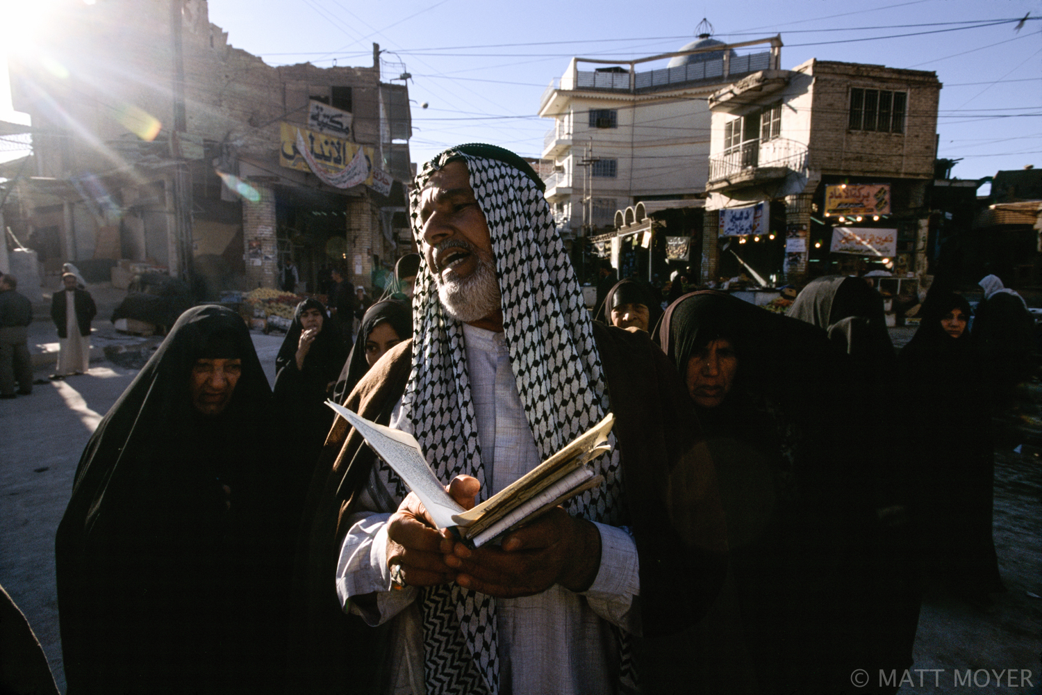  A Shiite man reads from the Koran outside the Imam Ali shrine in Najaf, Iraq. 