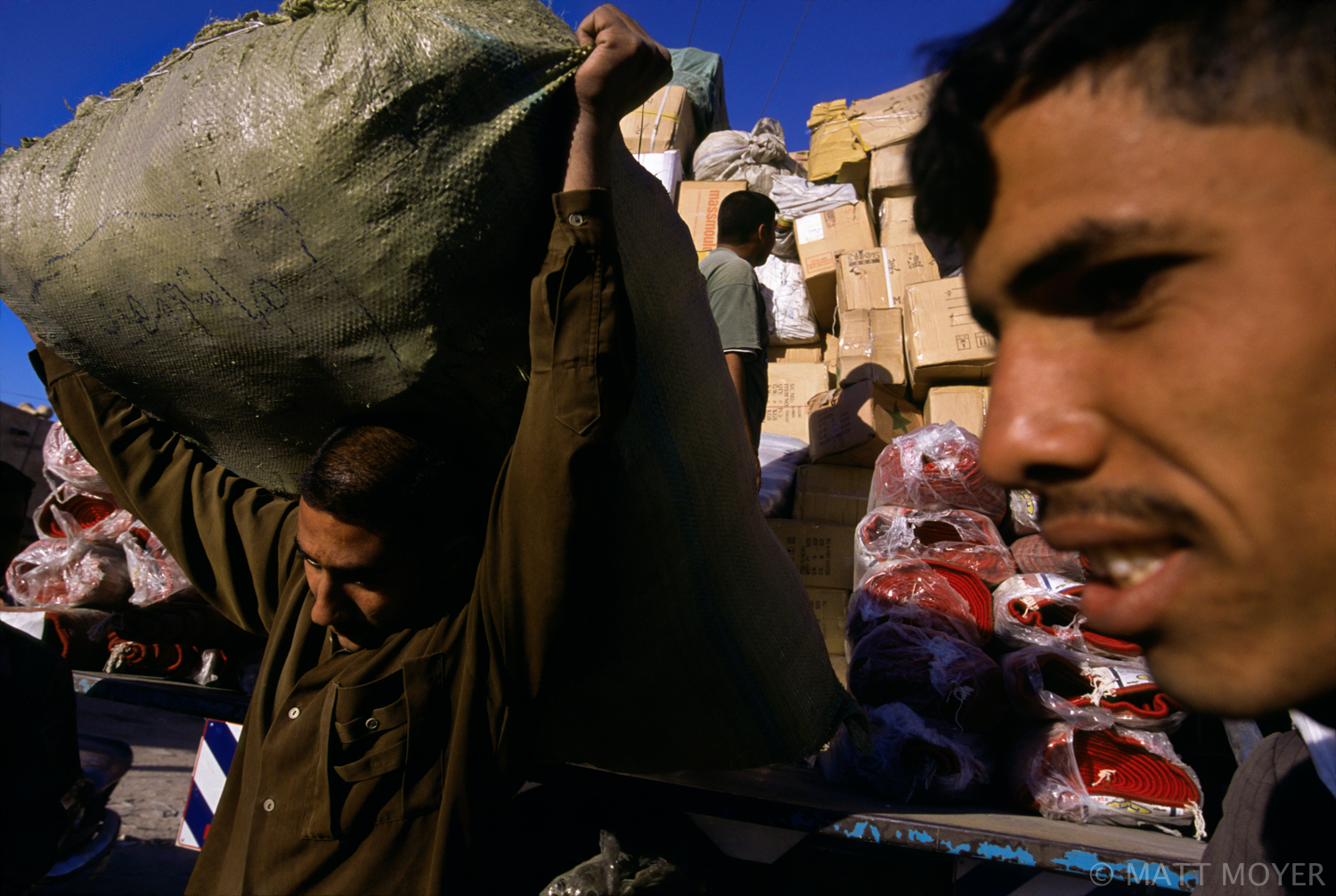  Goods are unloaded from a truck in Najaf, Iraq. 