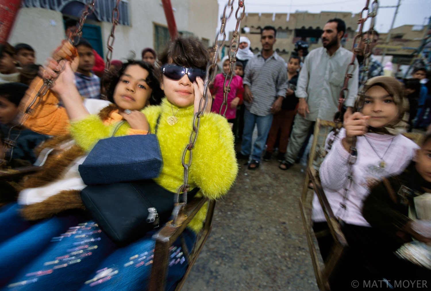  Local children line up for their turn to swing in Sadr City, Iraq, a shiite quarter of Baghdad. 