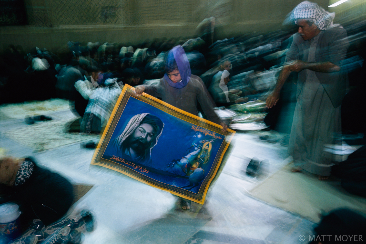  A young boy hawks posters of Imams in Najaf, Iraq. With the fall of Saddam Hussein’s regime the Shiites have emerged from decades of repression to seize the reins of power in Iraq. 