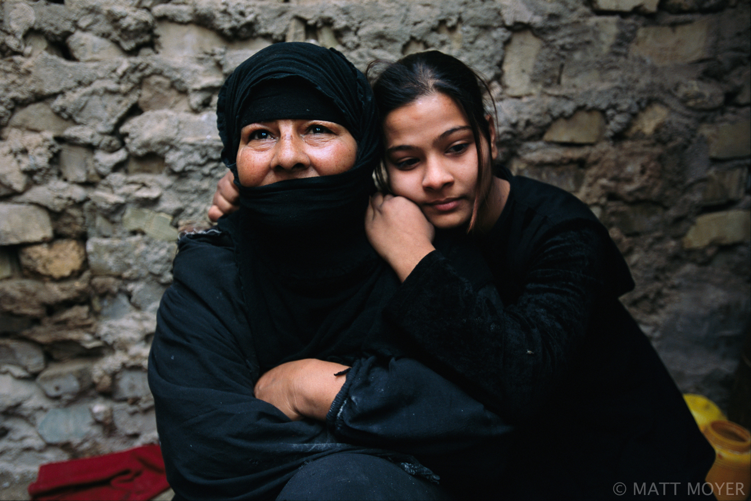  Noel Abdel Wahid (R), 14, and her mother Sadia share a tender moment in their outdoor kitchen at their home in the sprawling Shiite slum of Sadr City in Baghdad, Iraq. Noel is supposed to marry a cousin, who she does not want to marry, but feels she