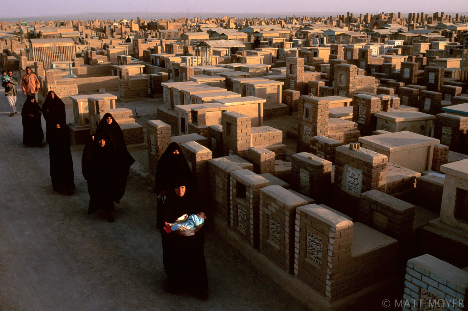  Shiite mourners walk through the Valley of the Peace Cemetery in Najaf, Iraq. 