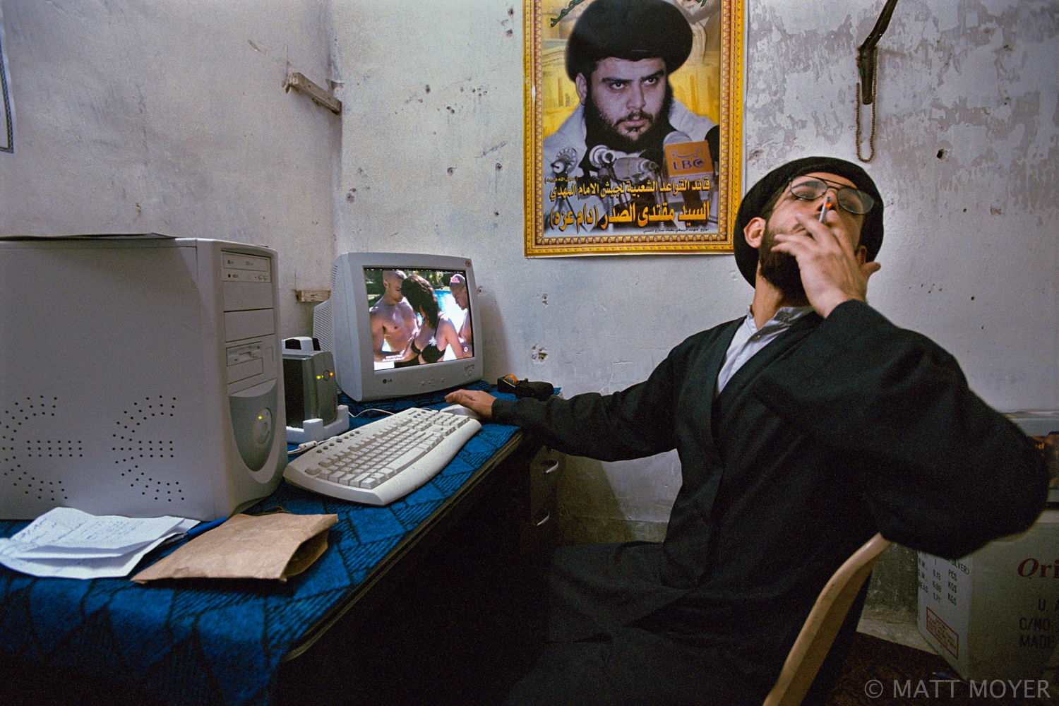  At a court set up by rebel cleric Moktada al-Sadr, a cleric smokes a cigarette after finding sexually explicit images on a confiscated CD in Najaf, Iraq. Najaf is patrolled by Sadr's own moral police and those caught selling CDs with illicit images 