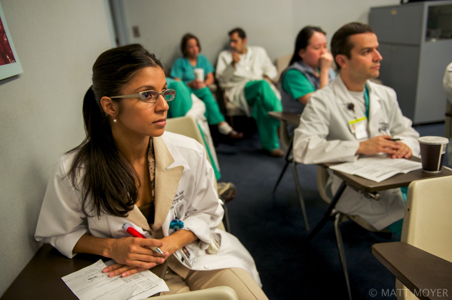  Dr. Carla Haack, left, a twenty five-year-old surgical resident, sits in on a medical briefing at Grady Memorial Hospital. 