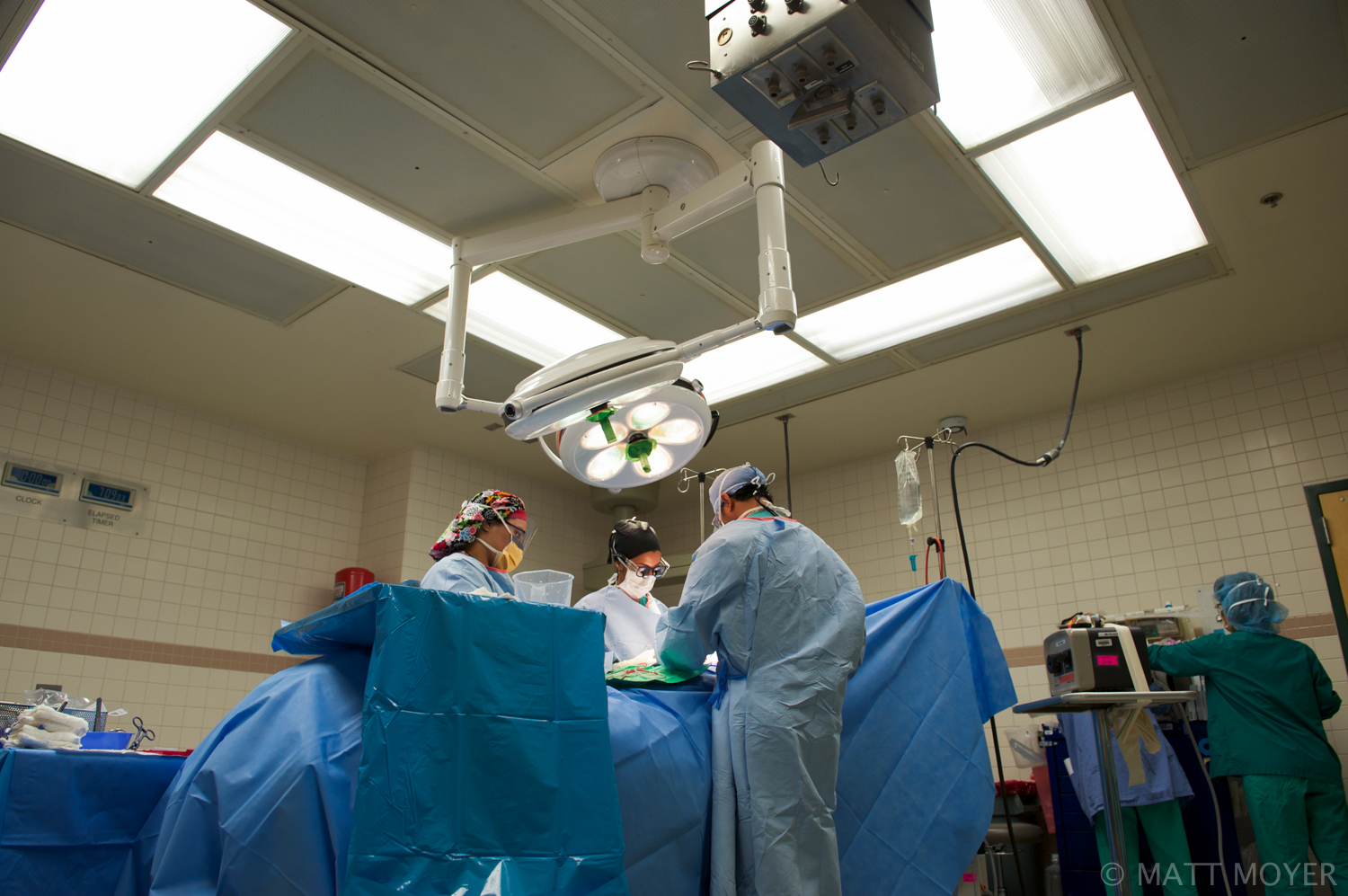  Dr. Carla Haack, center, a twenty five-year-old surgical resident, assists in a surgery at Grady Memorial Hospital. 