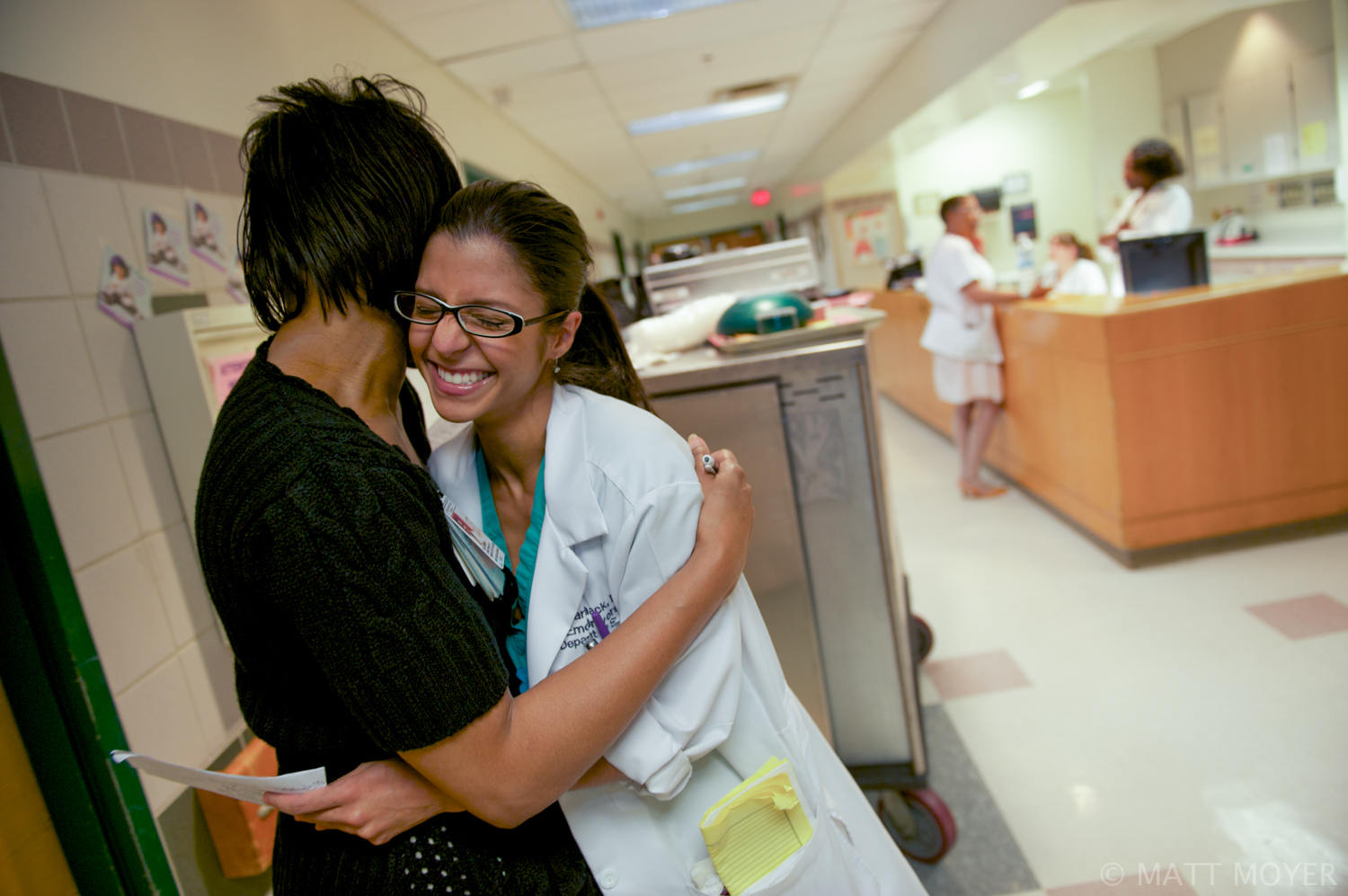  Dr. Carla Haack, a twenty five-year-old third year surgical resident, hugs a friend while doing her morning rounds at Grady Memorial Hospital. 