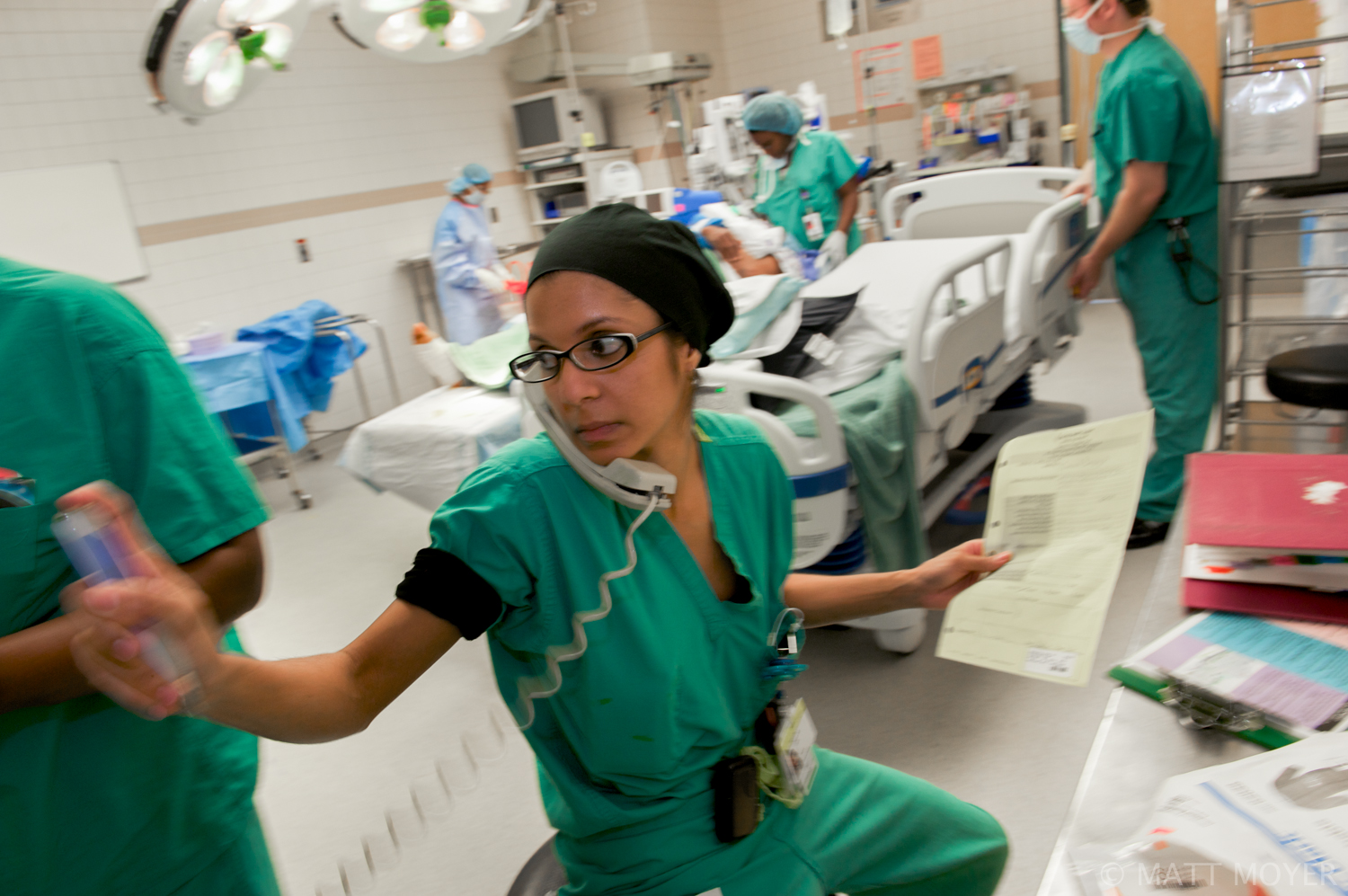  Dr. Carla Haack, a twenty five-year-old surgical resident, multi tasks after completing a surgery at Grady Memorial Hospital. 