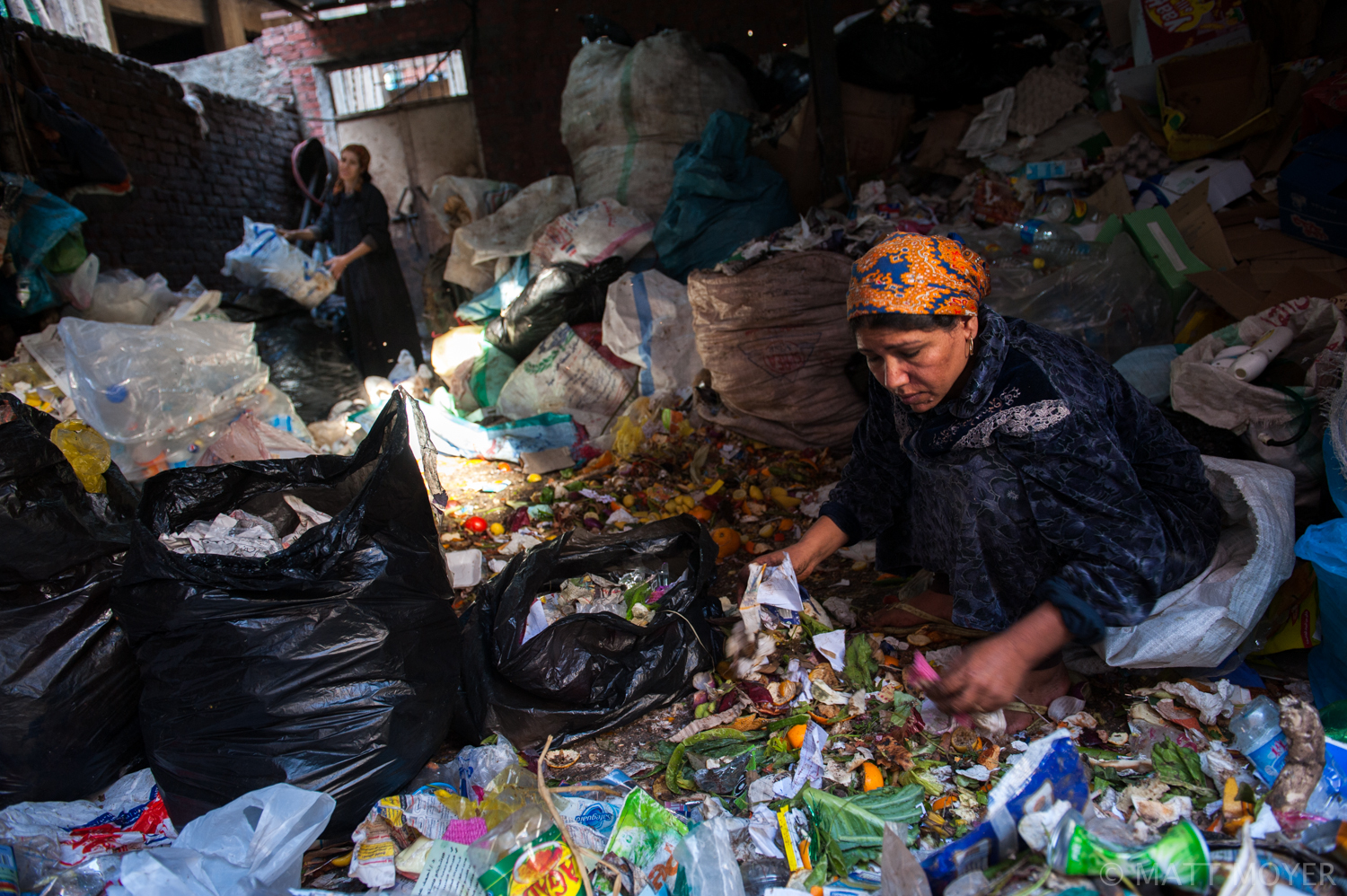  A woman sorts through trash in a Christian part of Cairo, Egypt. 