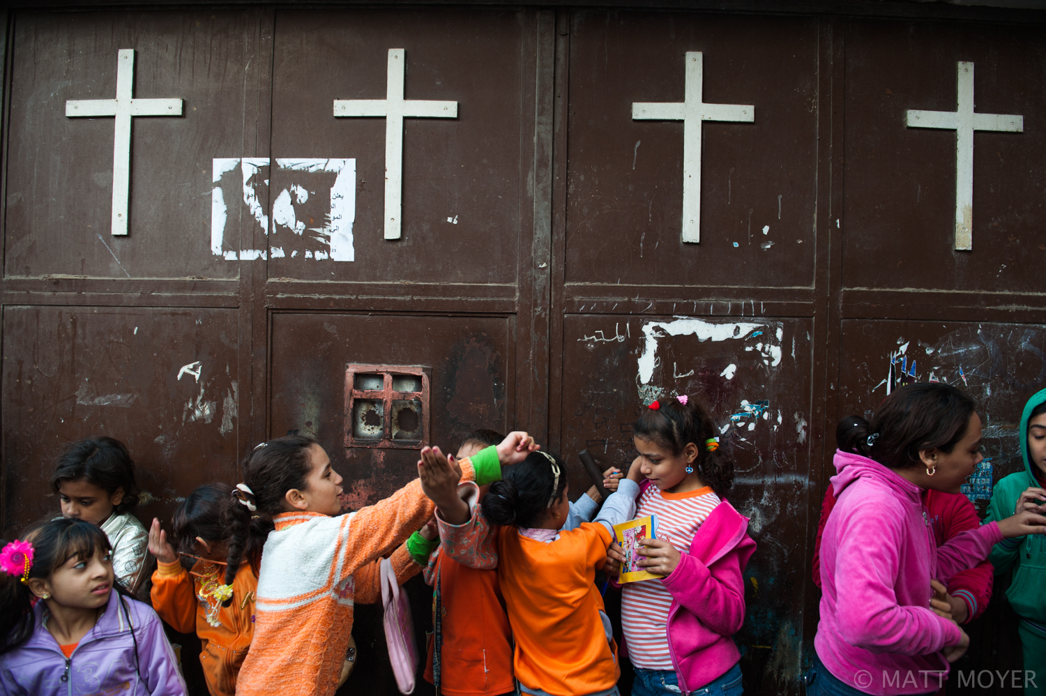  Egyptian Christian children wait outside a Christian Monestary. 