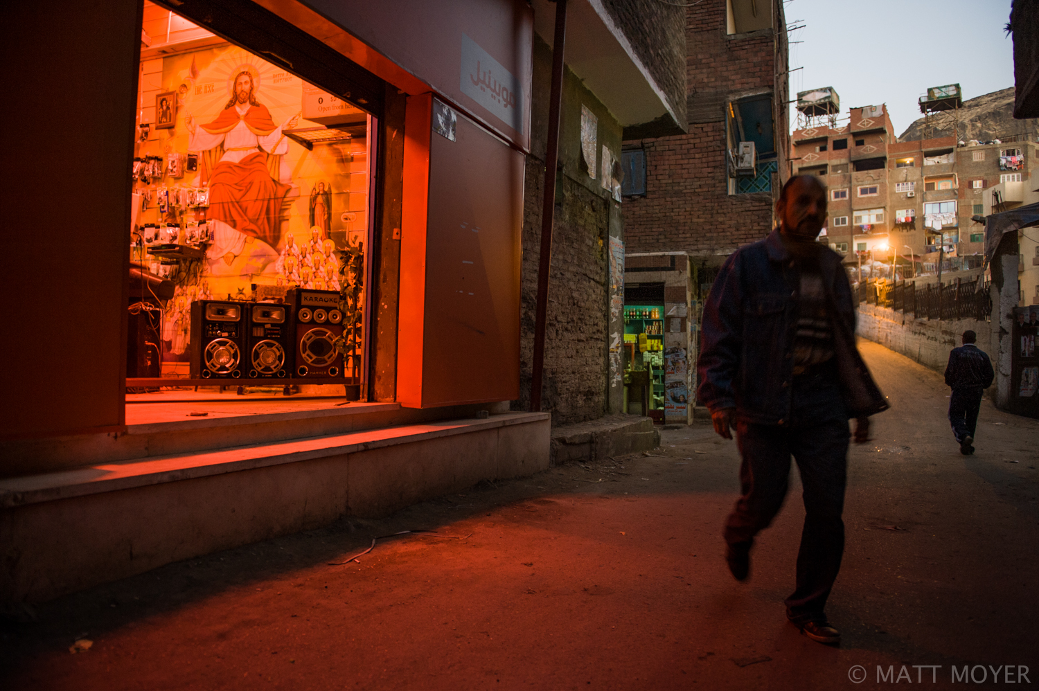  An Egyptian man passes a mobile phone store with a huge mural of Christ in a Christian neighborhood in Cairo, Egypt. Many Christian Egyptians have expressed concern with the unpredictable political situation in their country, the growing power of Is