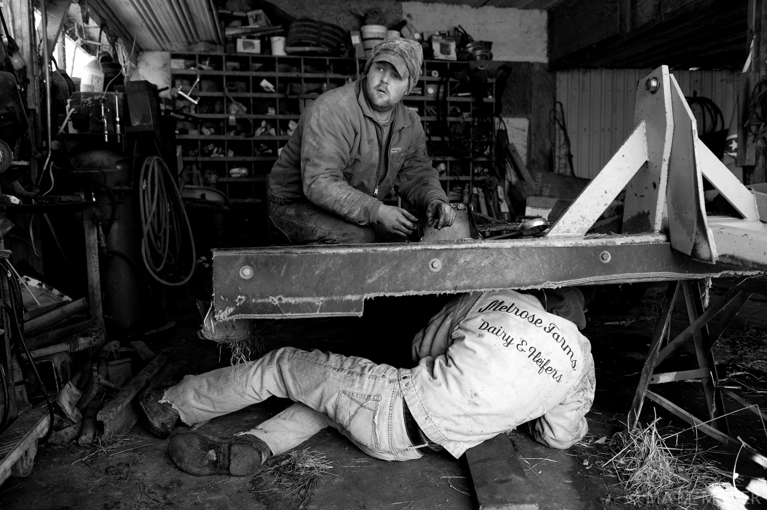  Ed Tidd, top, works on farm equipment with his brother, Andrew, on the Tidd farm in Auburn, NY. Ed runs a small dairy farm with his father in upstate New York. 