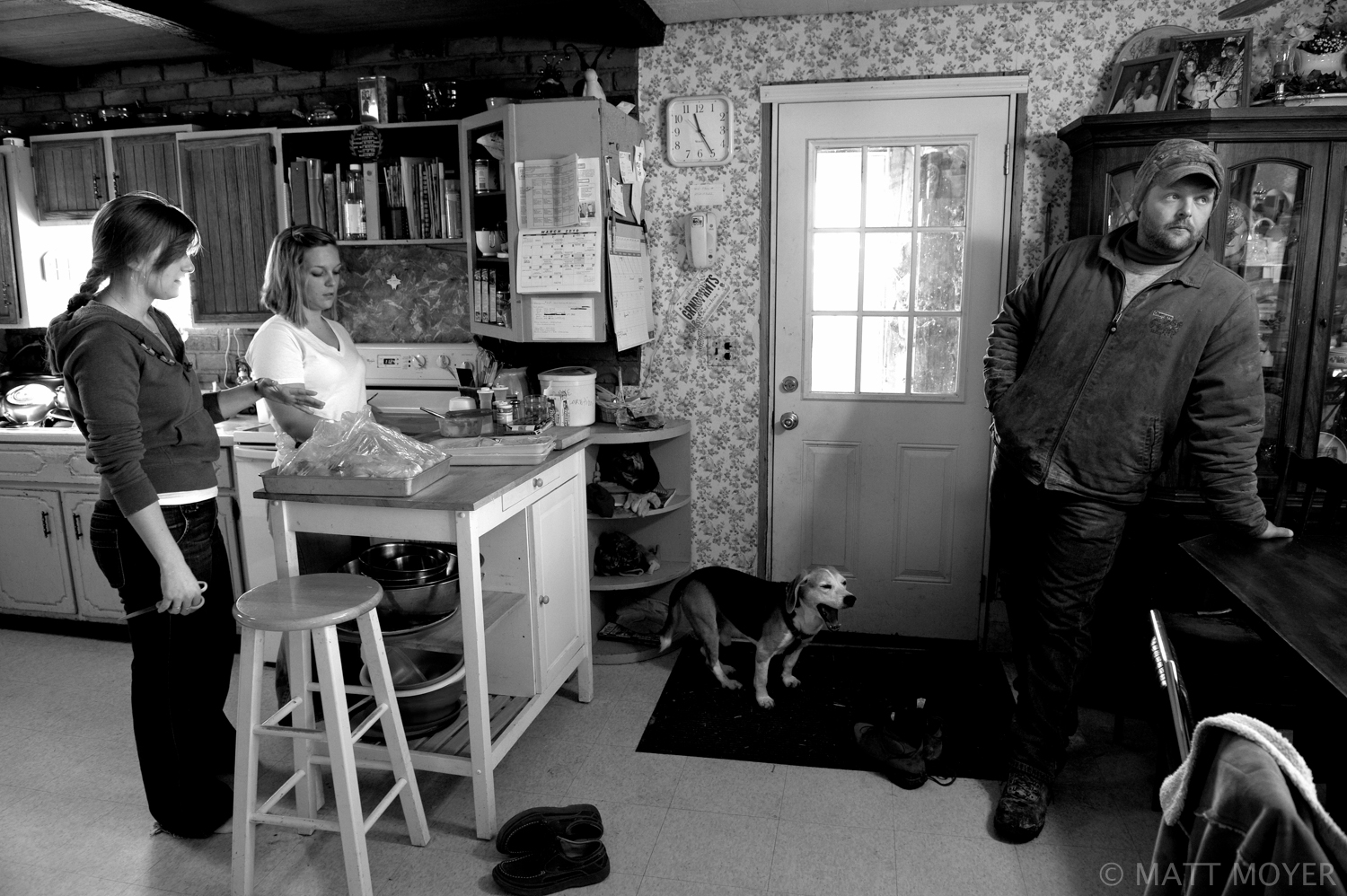  Meghan Nutting, left, and Jessica Tidd prepare a meal for a Sunday family dinner as Ed Tidd, right, prepares to head to the barn to do chores at the Tidd home in Auburn, NY. 